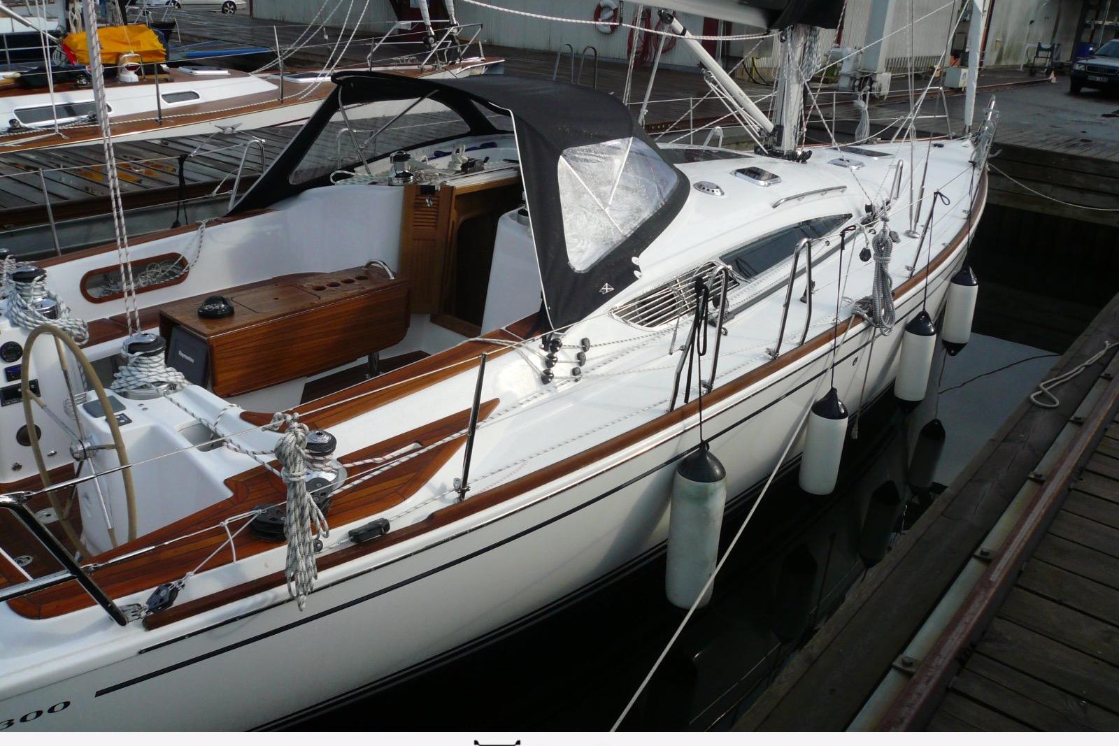 Sleek 2010 Maxi 1300 sailboat docked, featuring elegant wood accents and modern design.