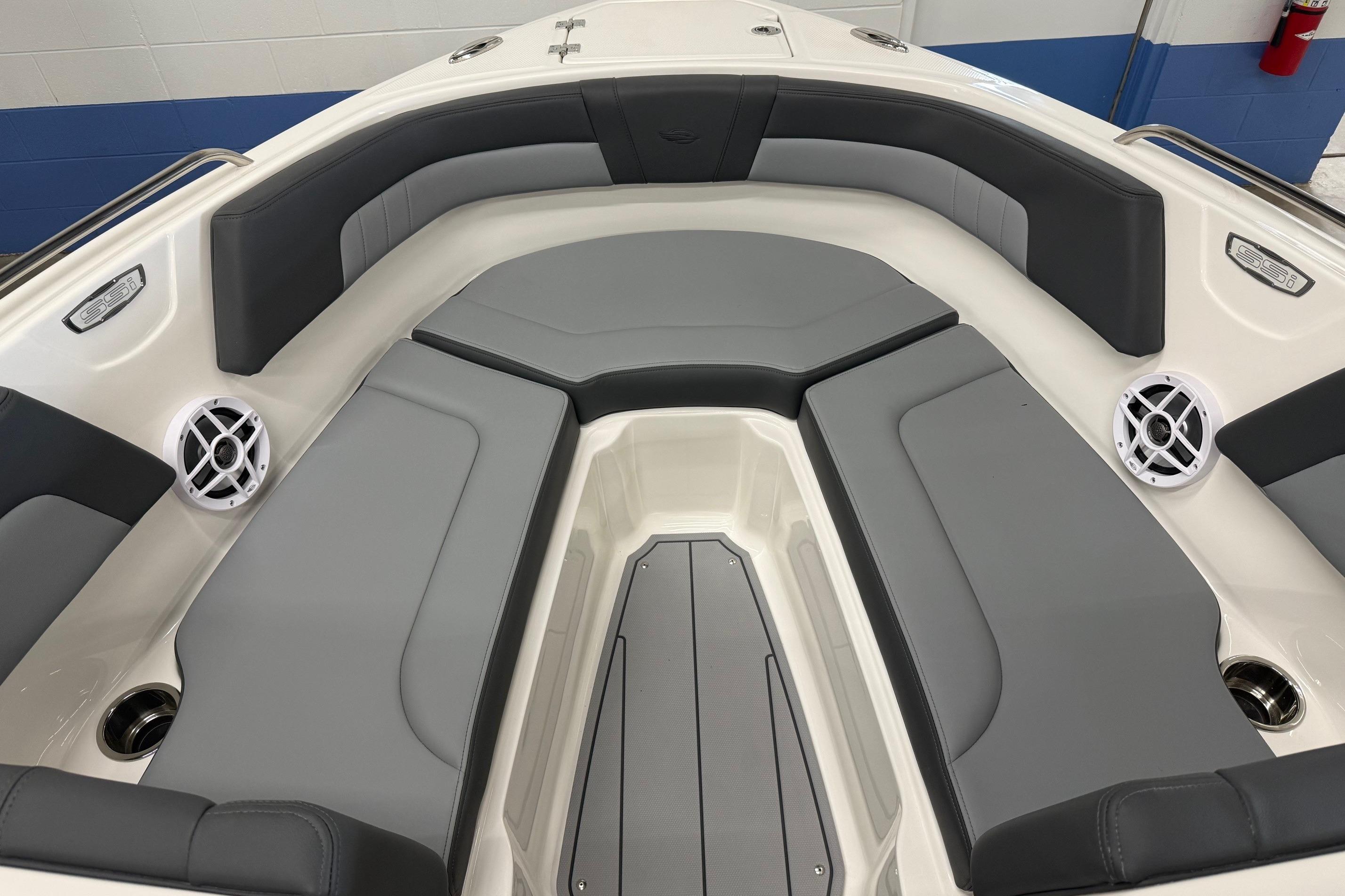 2026 Chaparral 23 SSi boat interior with gray seating and speakers.