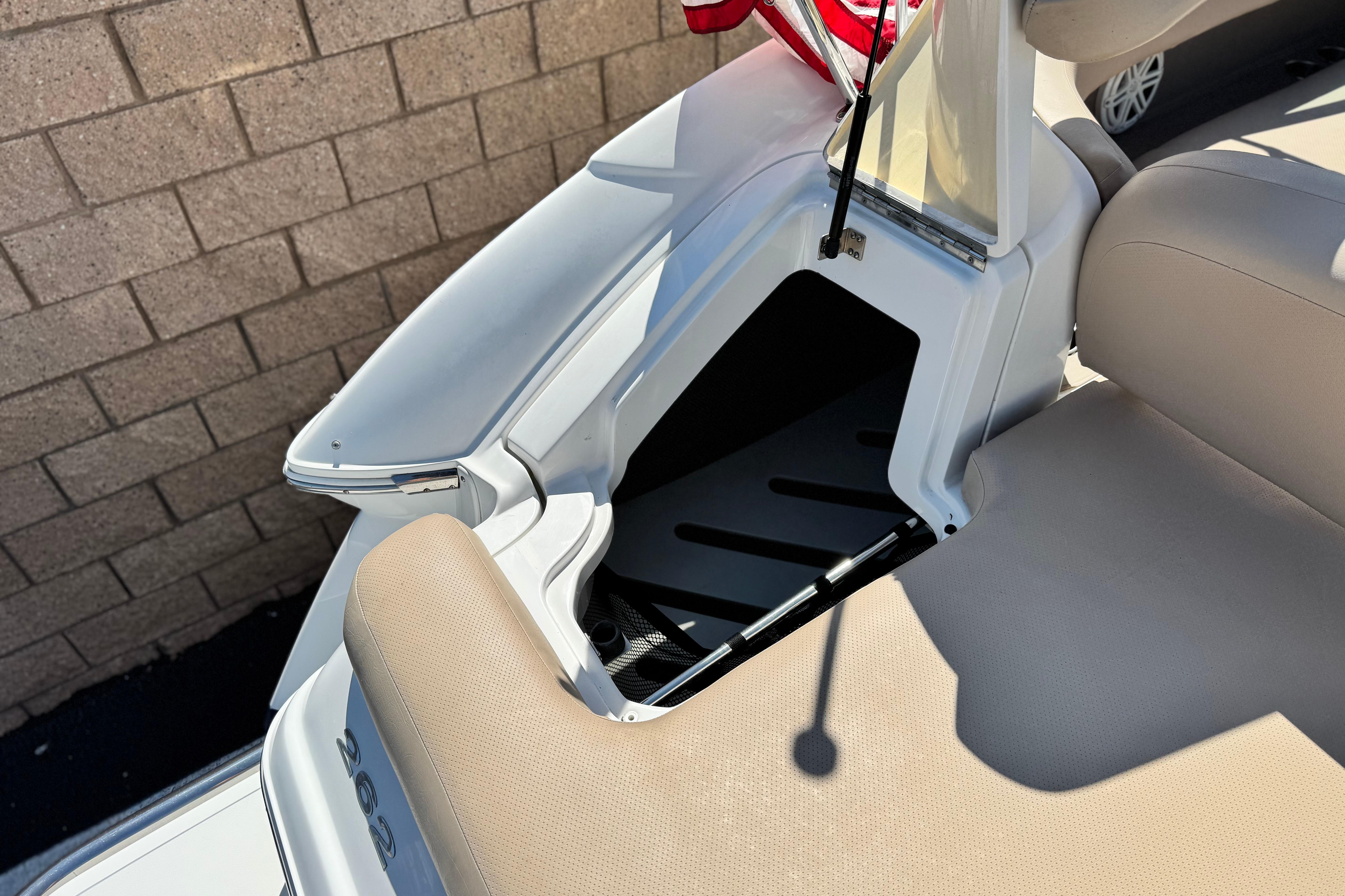 2008 Cobalt 262 boat interior with open storage compartment and beige seating.