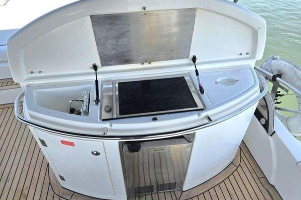 Outdoor kitchen on 2005 Sunseeker Manhattan 66 yacht with grill and sink.