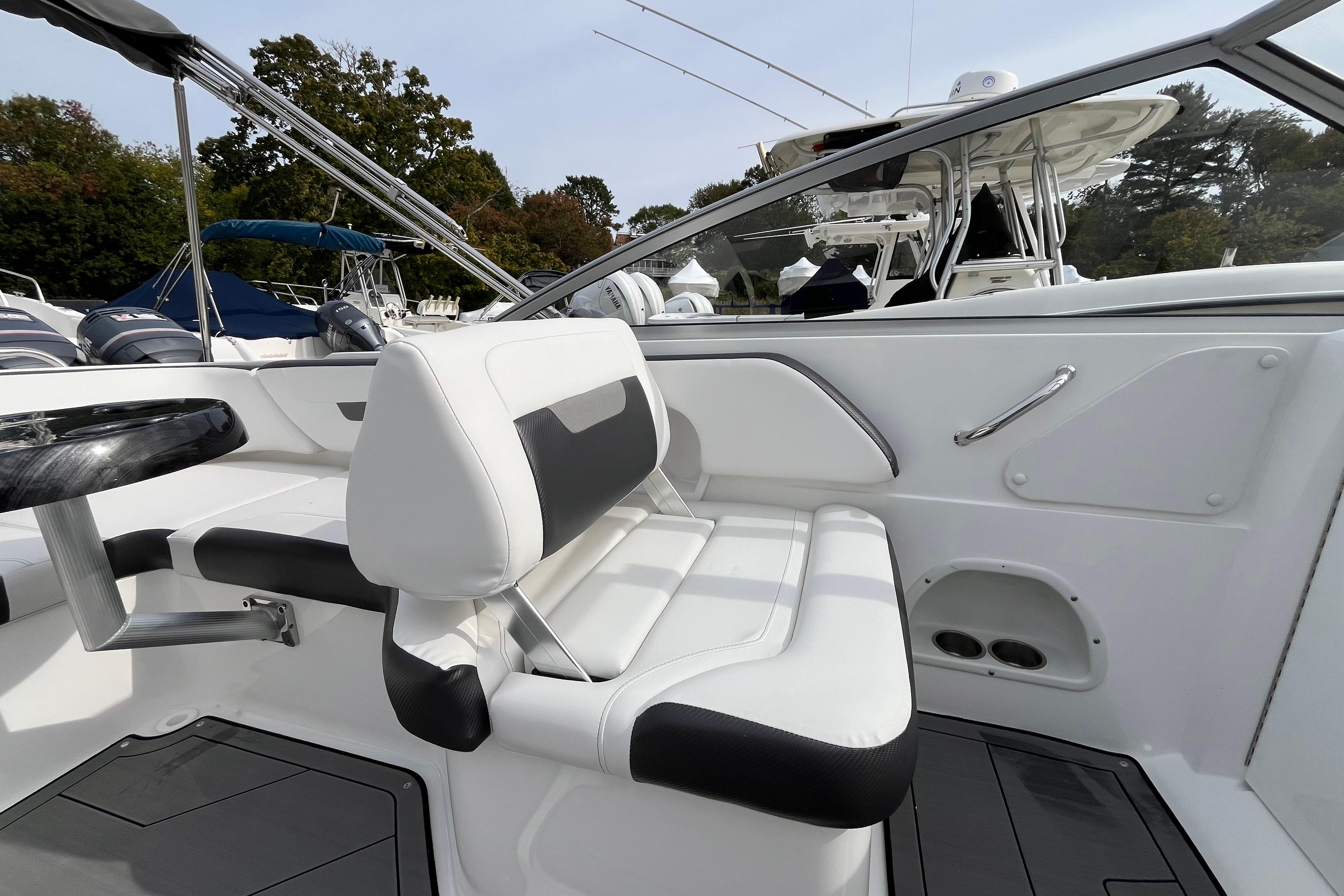 2023 Hurricane SunDeck 235 OB boat interior with white seating and sleek design.
