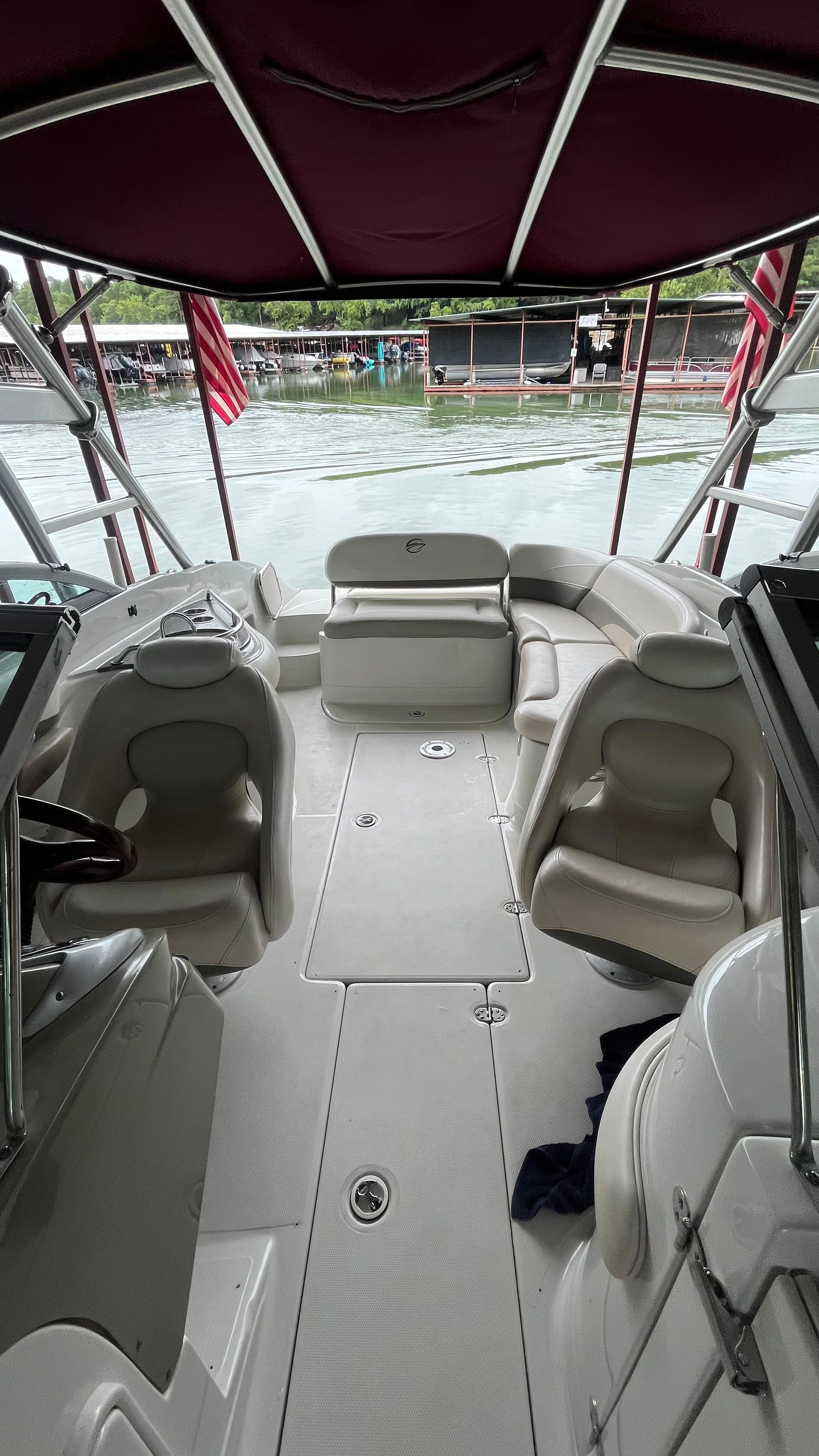 Interior view of a 2008 Crownline 252EX boat with seating and a view of the water.