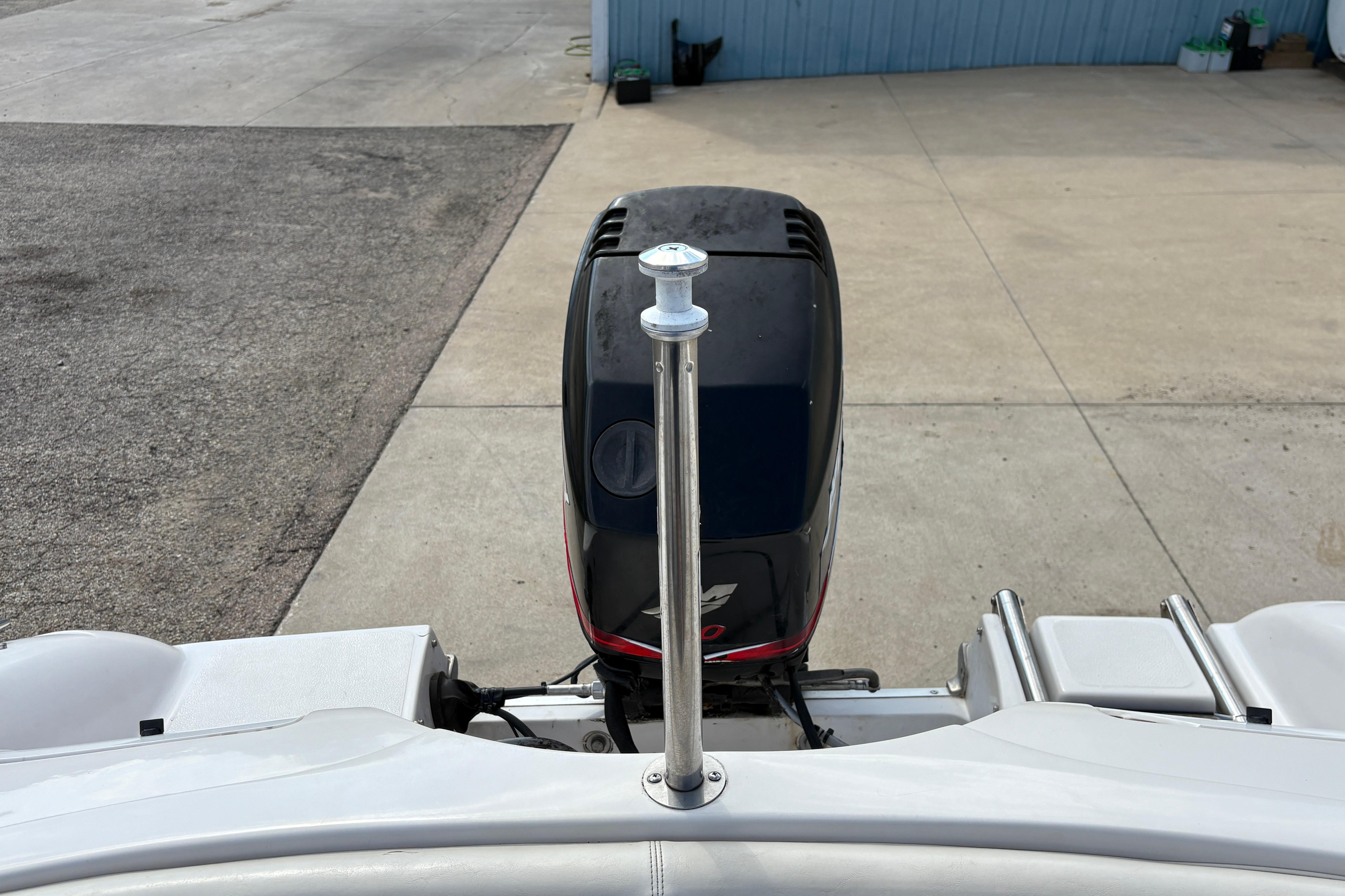 2005 Starcraft C-Star 1700 OB boat with outboard motor on a concrete surface.