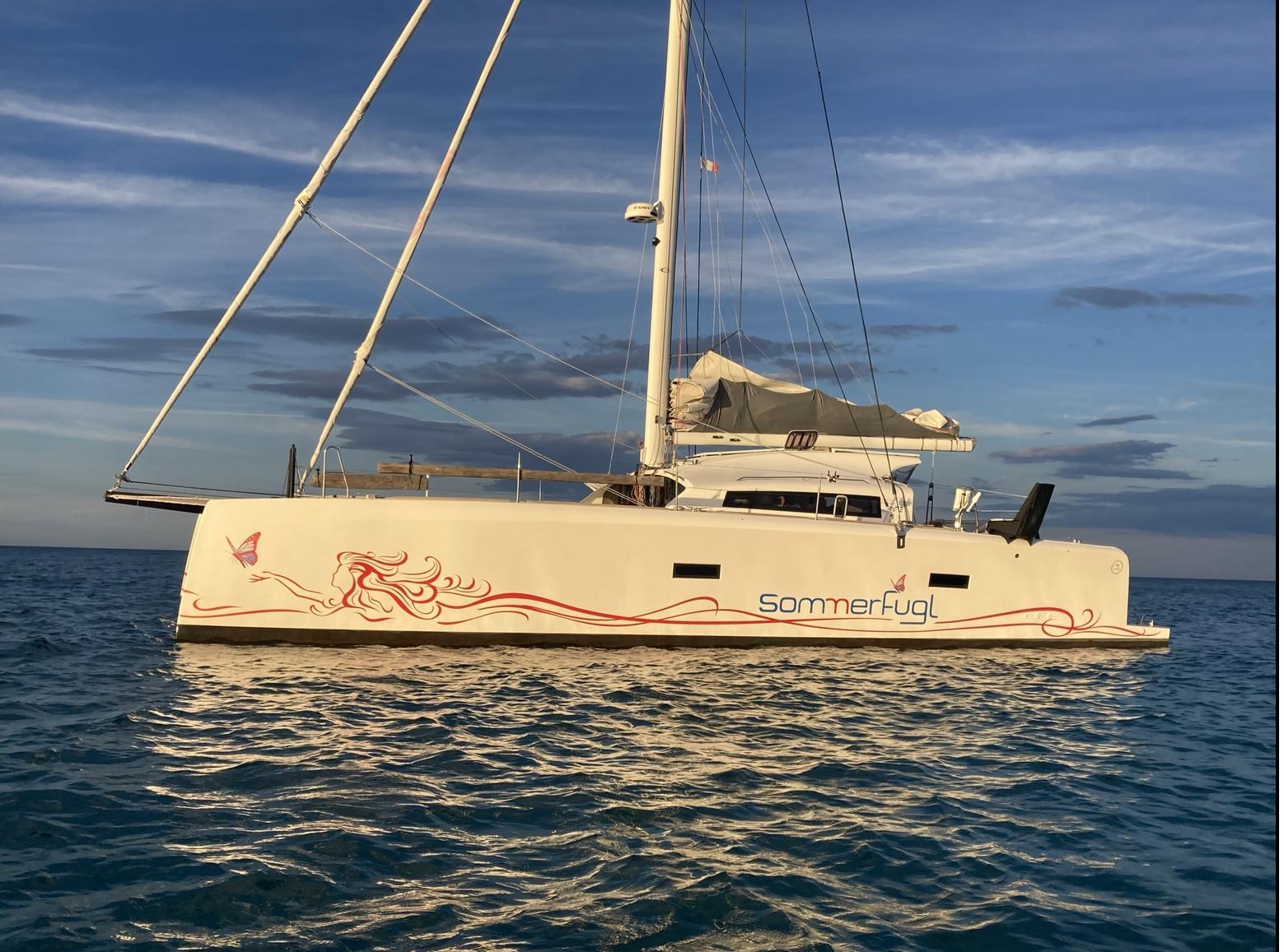 Marsaudon Composites TS42 catamaran 2016 on calm sea at sunset.
