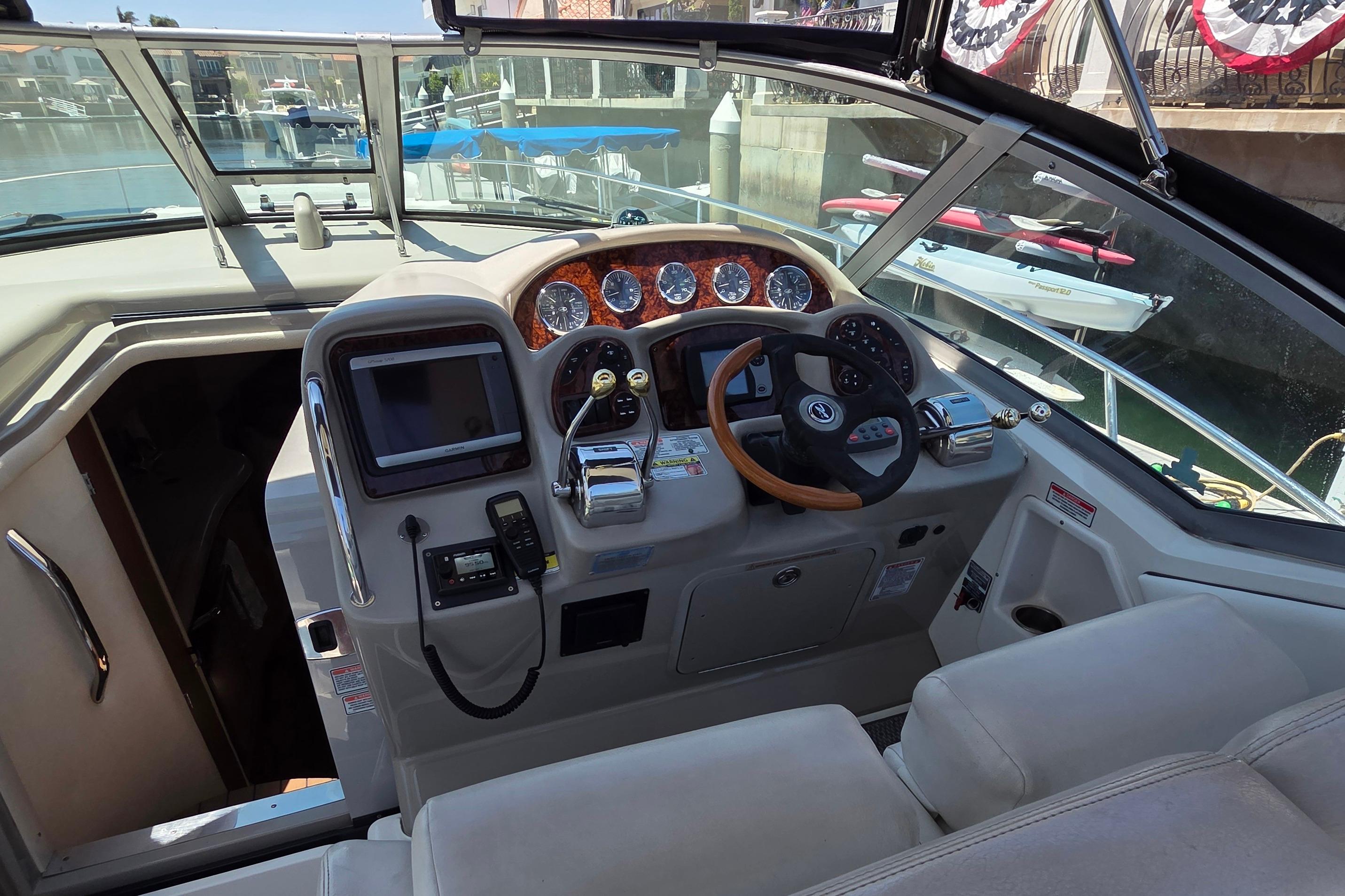 Cockpit of 2006 Sea Ray Sundancer 320 with steering wheel and control panel.