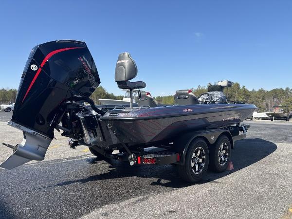 2025 Phoenix 920 Elite boat on trailer, featuring powerful outboard motor, parked outdoors.