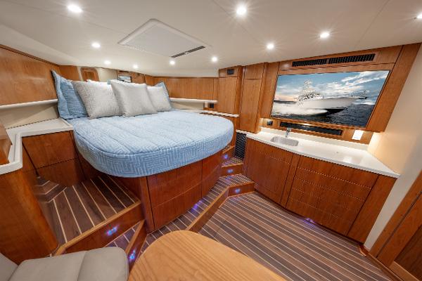 2025 Albemarle 36 Express cabin with bed, TV, and wooden interior.