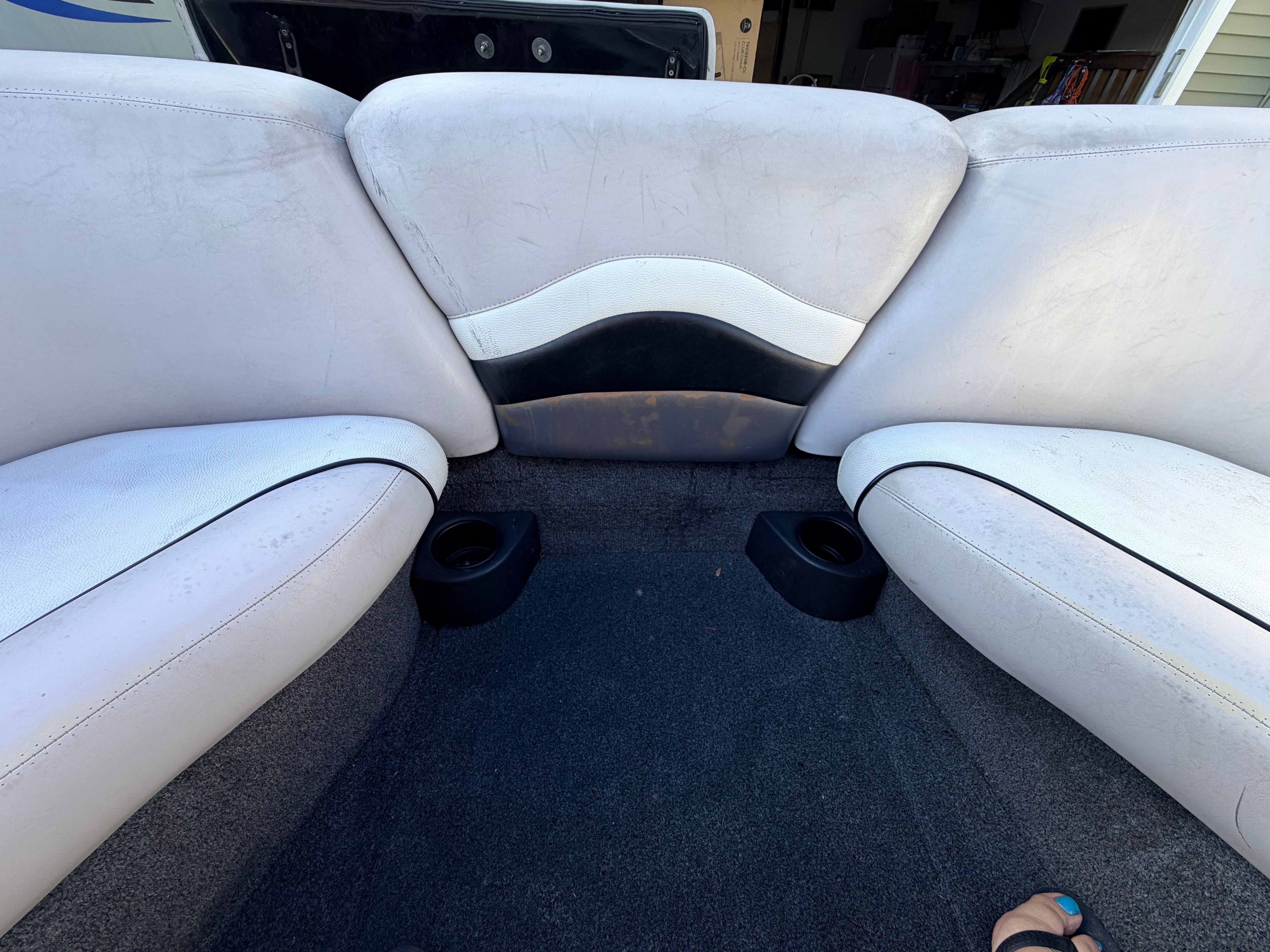 Interior of a 2006 Malibu iRide boat with white seats.