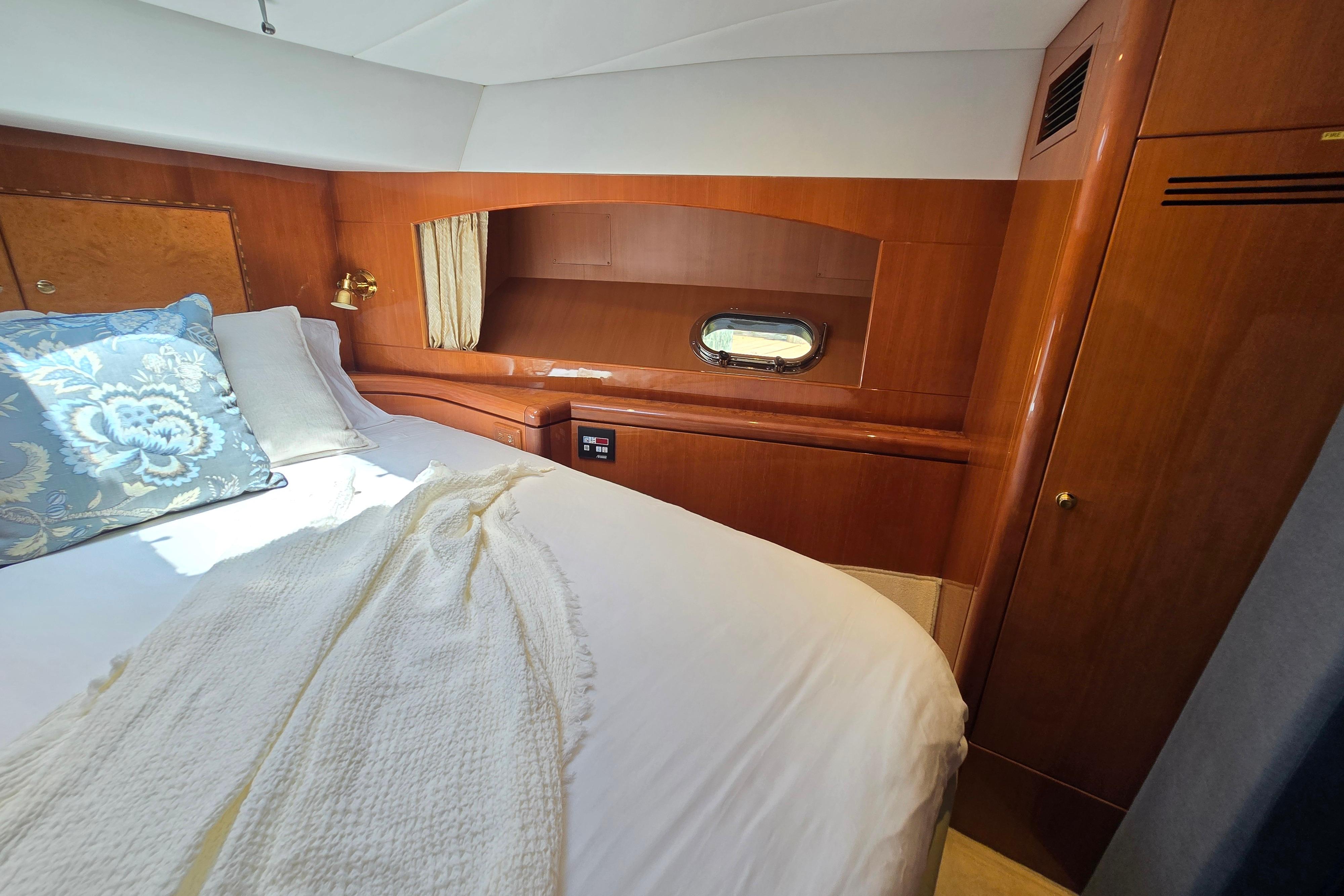 Luxurious cabin interior of 2004 Grand Harbour 58 yacht with elegant wood finish.