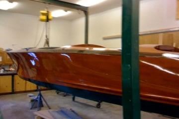 1931 Hacker-Craft 26 Dolphin boat in workshop, showcasing sleek wooden design.