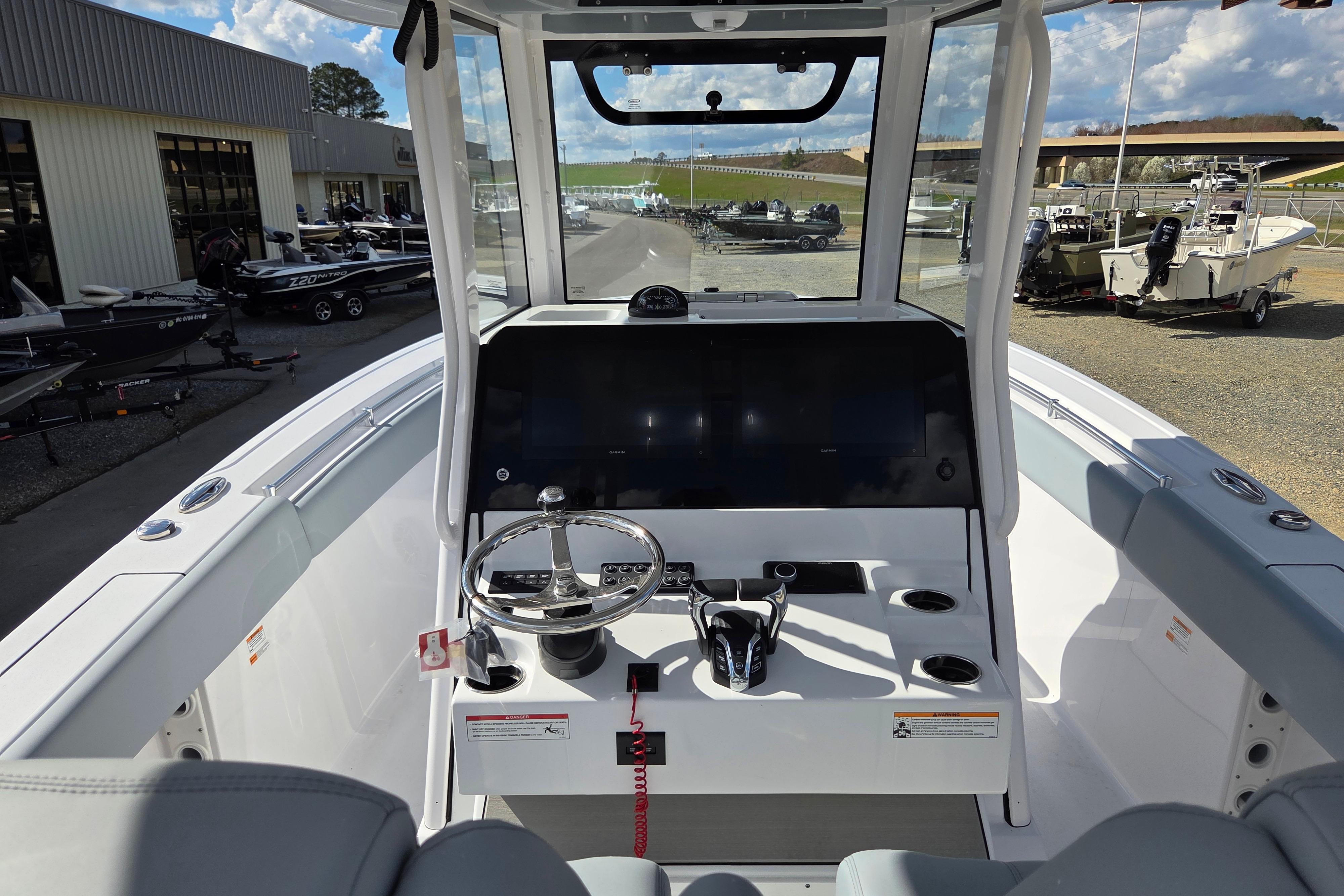 2026 Sportsman Open 282 Center Console boat interior with steering wheel and dashboard.