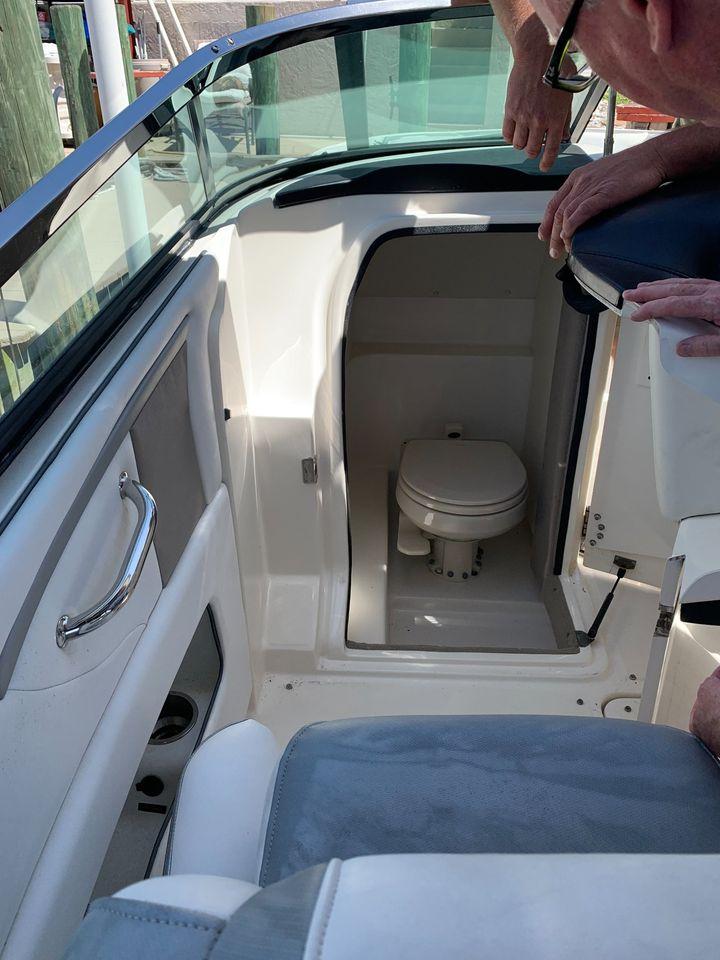 2006 Sea Ray 250 SLX boat interior with compact marine toilet.
