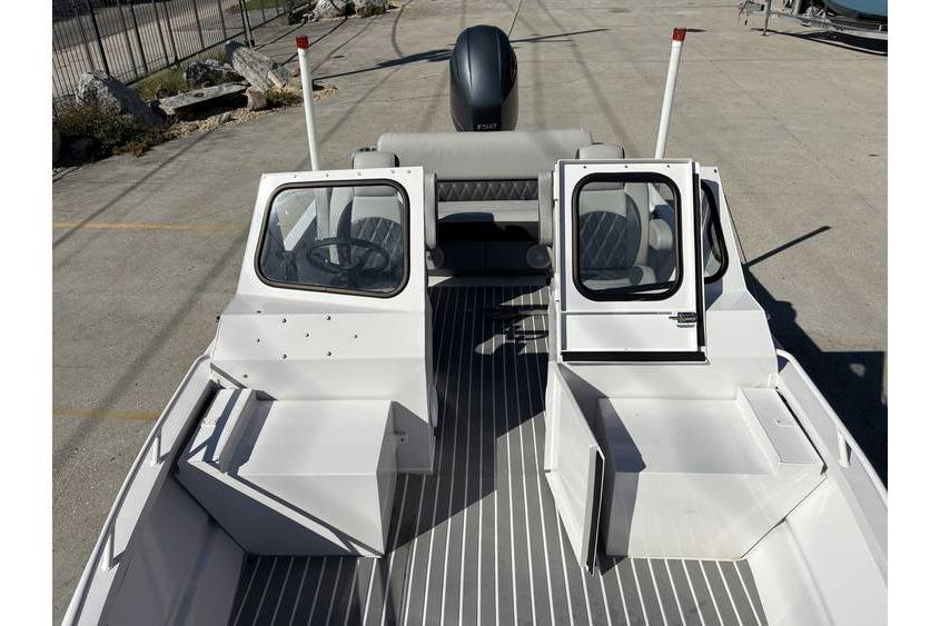 1997 Scully's 18 WT boat interior with open cabin doors and steering wheel.