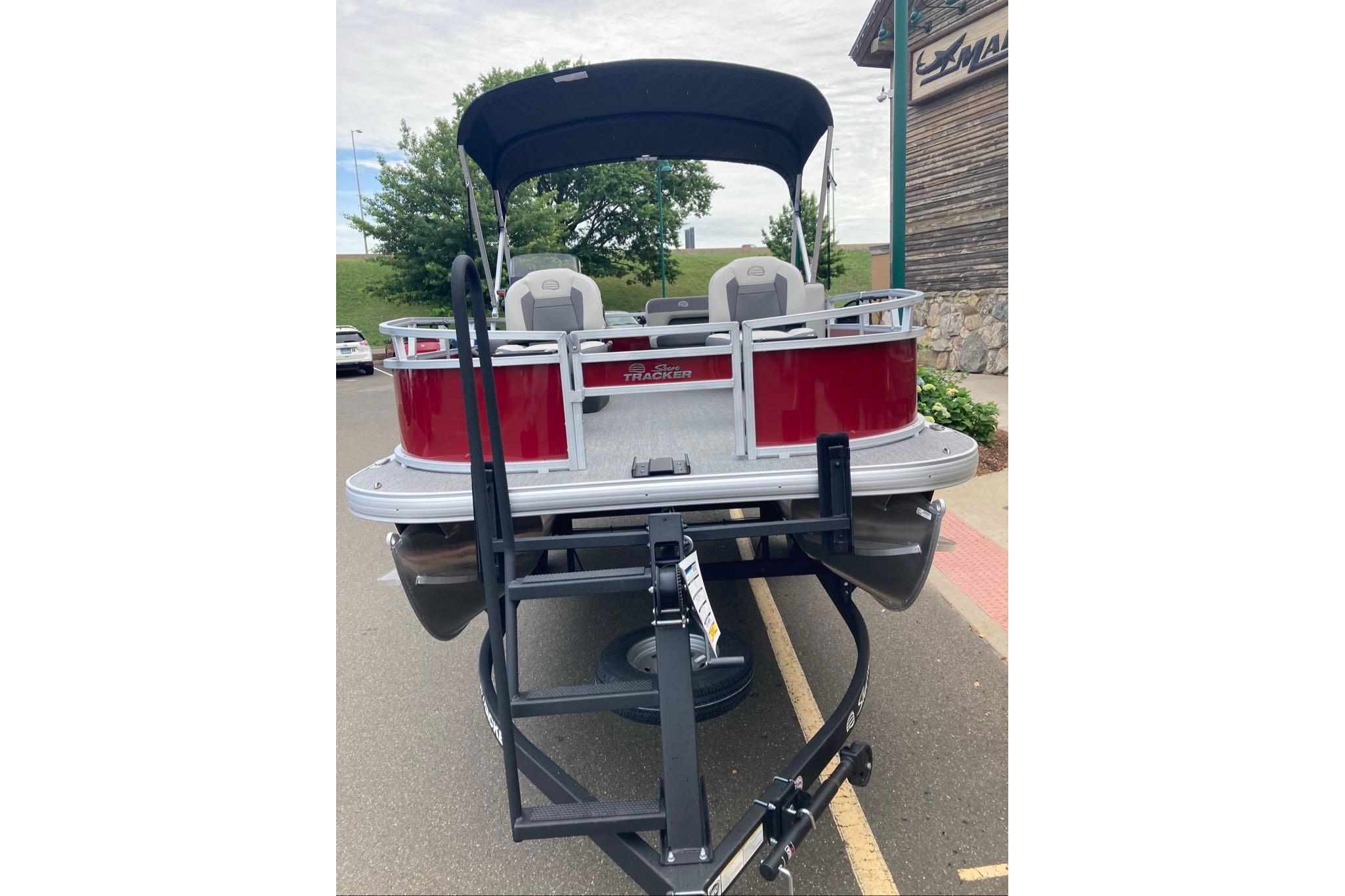 2026 Sun Tracker Bass Buggy 16 XL Select pontoon boat on trailer, rear view.