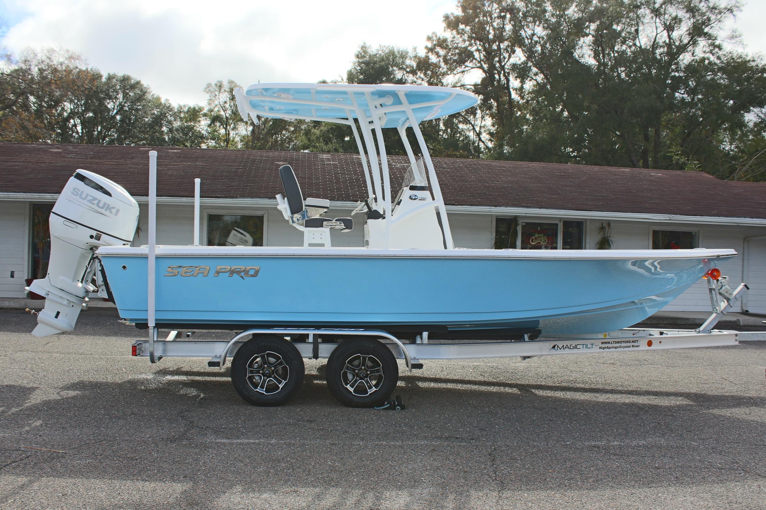2025 Sea Pro 230 Bay boat on trailer, featuring Suzuki outboard motor.