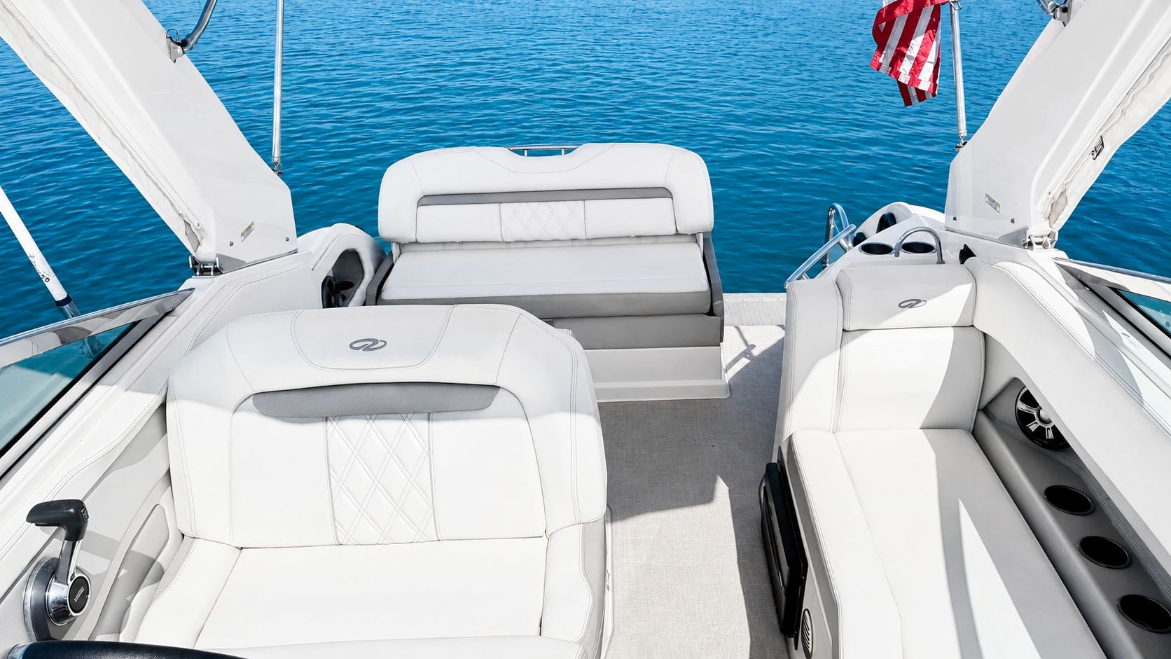 Interior of a 2020 Regal 28 Express with white seating on calm water.