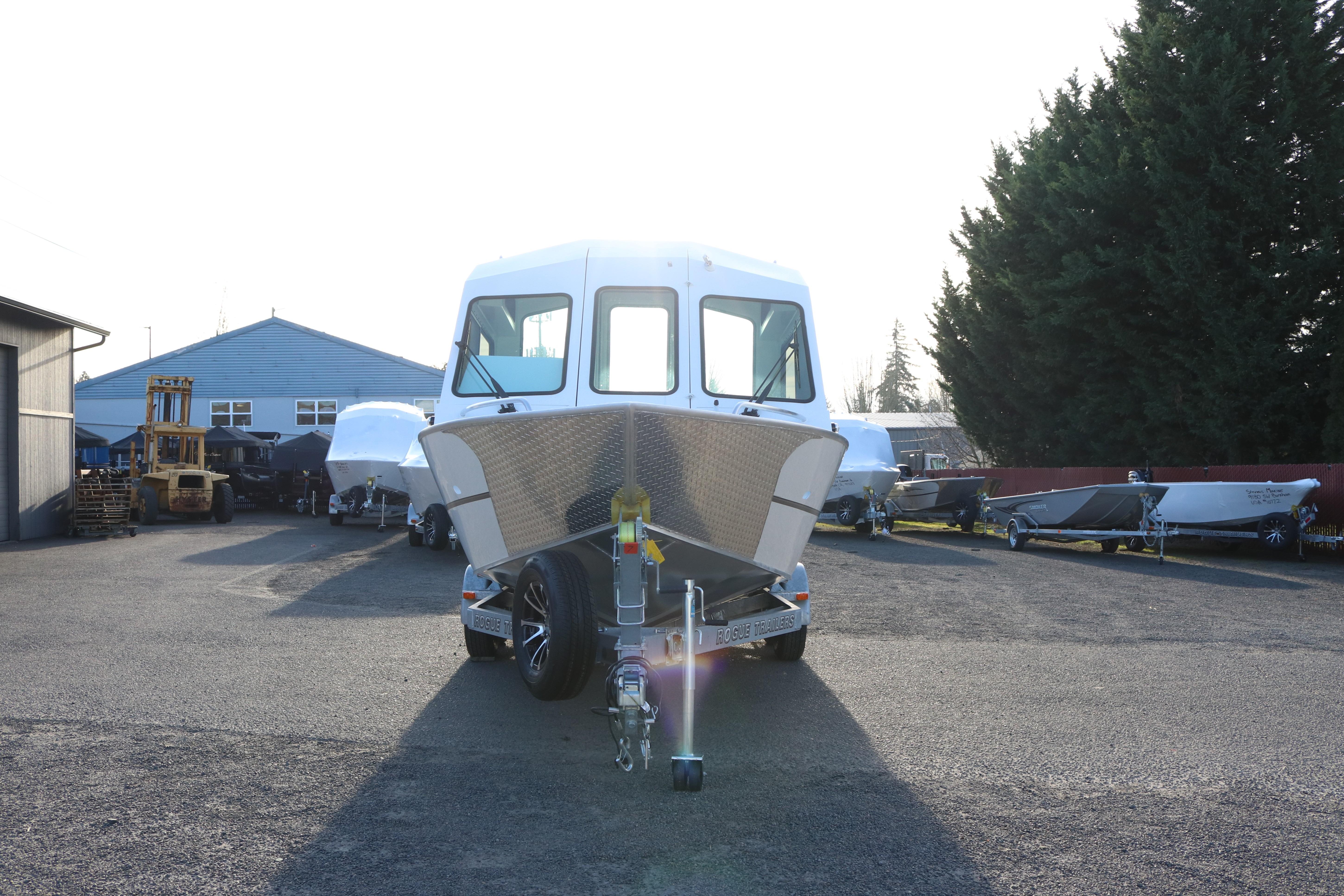 2026 Alumaweld Intruder Outboard 22 boat on trailer in outdoor lot.