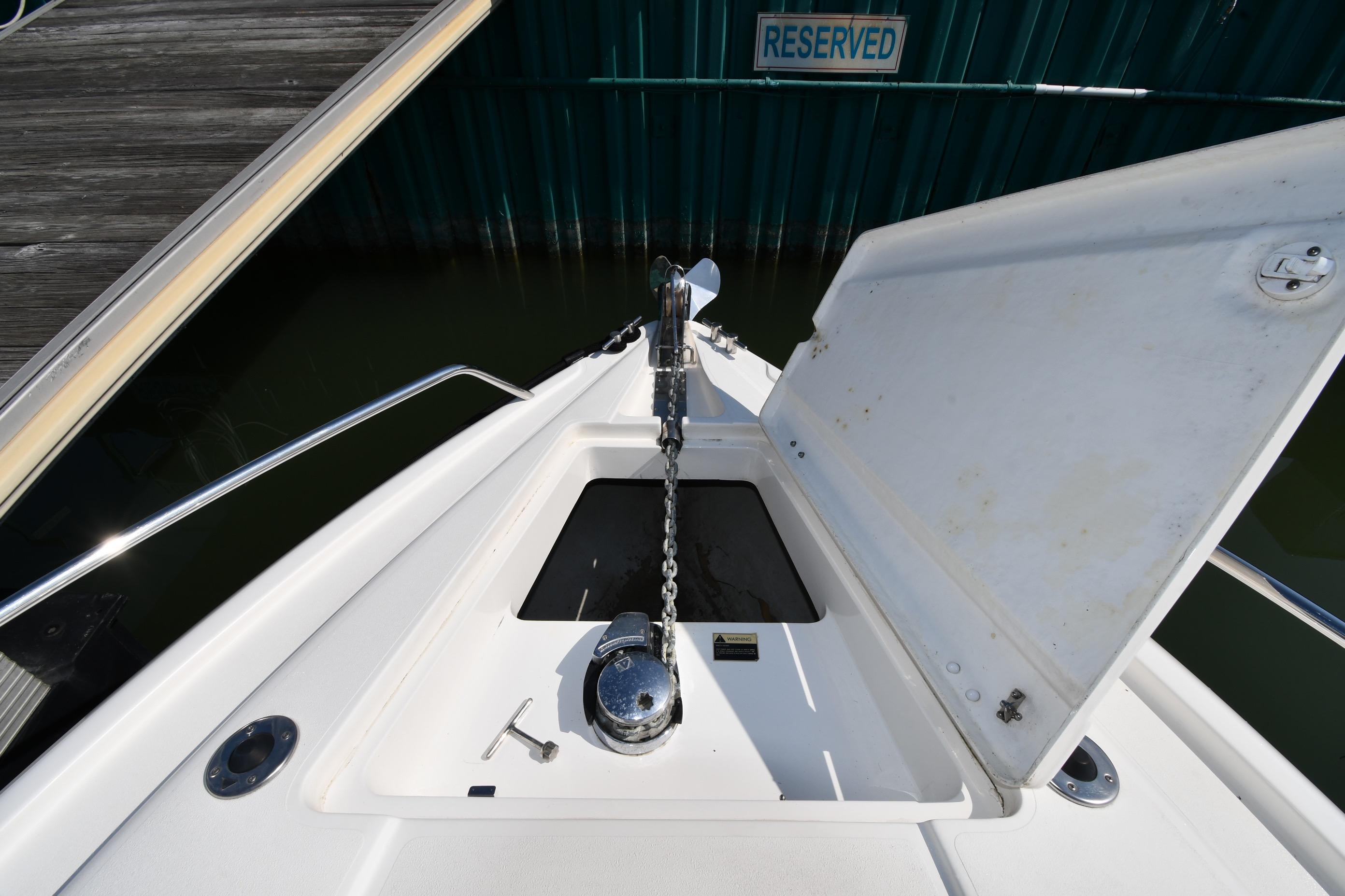 Bow anchor compartment of 2000 Sunseeker Superhawk 34 yacht, docked in reserved marina space.