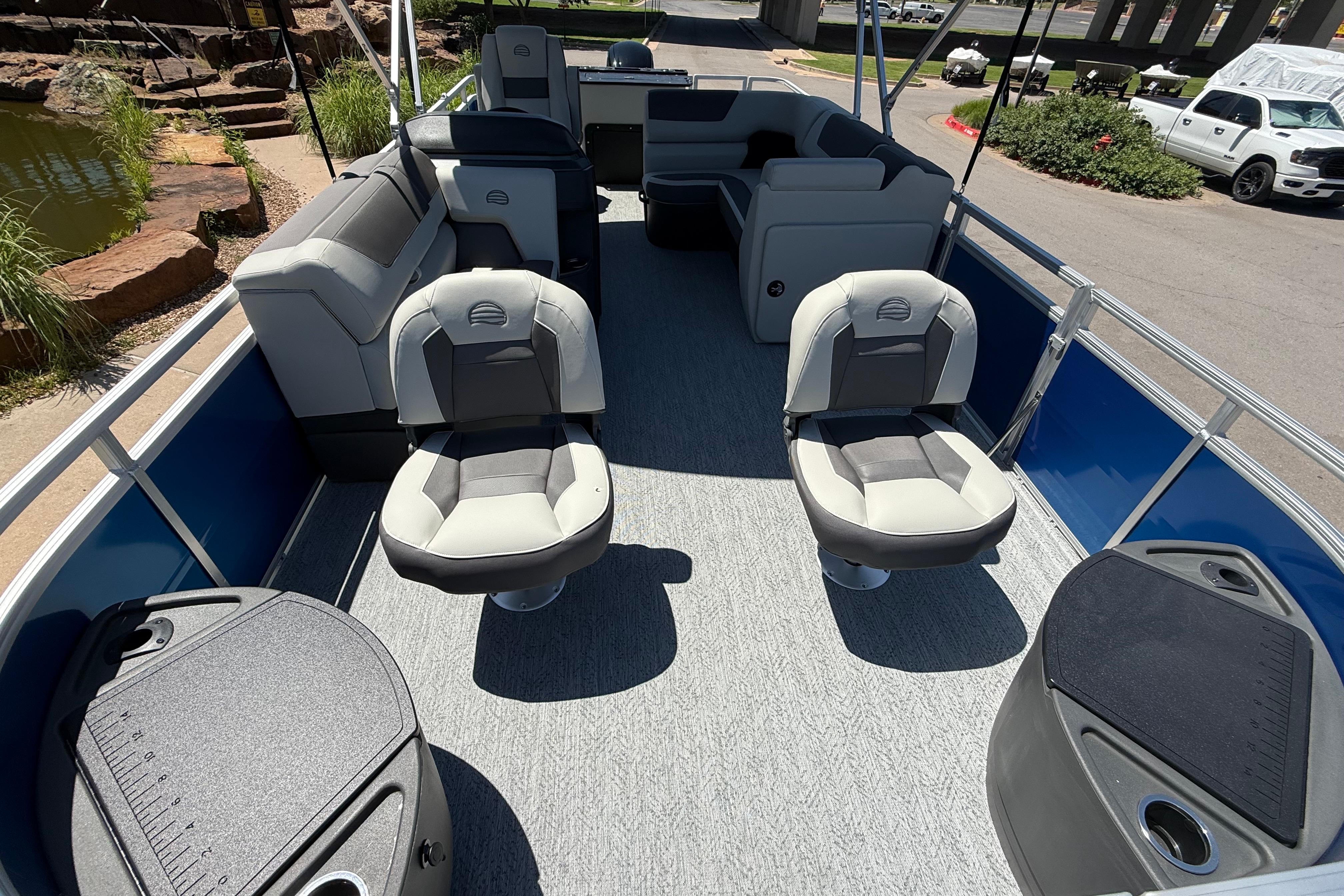 2026 Sun Tracker Fishin' Barge 20 DLX interior with seating and fishing amenities.