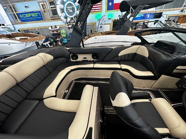 Luxurious interior of 2024 MB F22 Tomcat boat with beige and black seating.