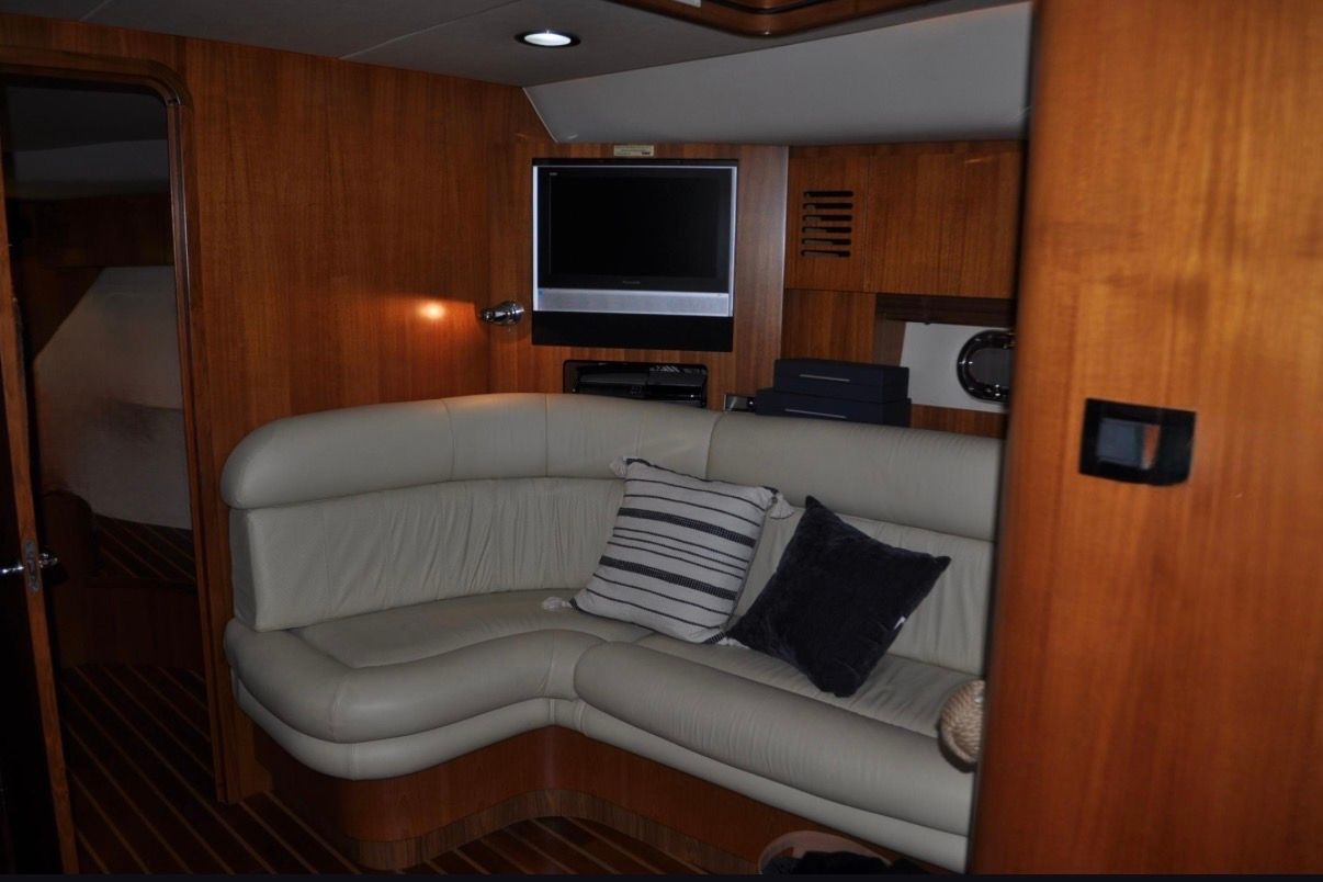 Interior of the 2005 Tiara Yachts 5200 Sovran with leather sofa and TV.
