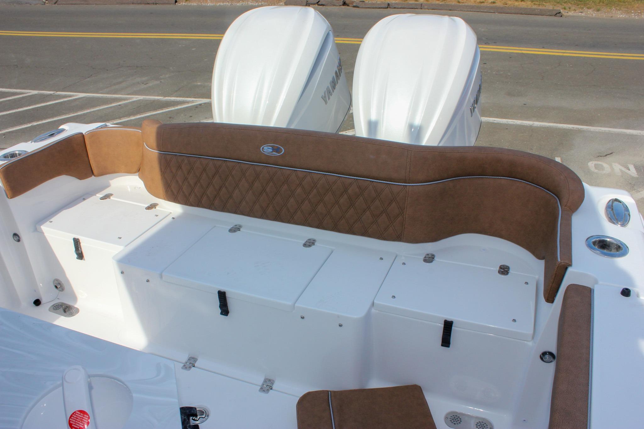 2027 Sea Hunt Ultra 275 SE boat with brown cushioned seating and dual engines.