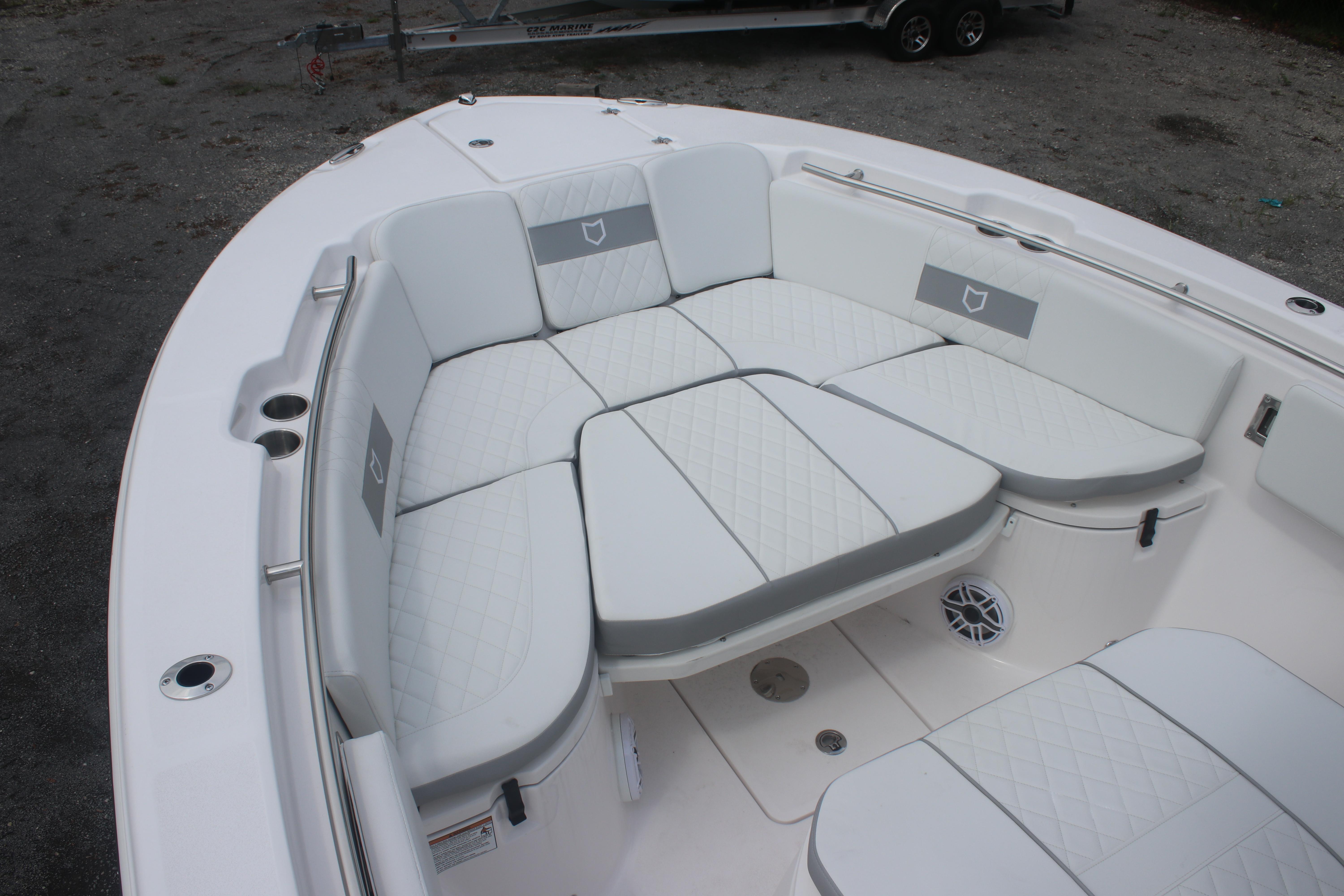 2026 Sea Fox 288 Commander boat with spacious white cushioned seating area.