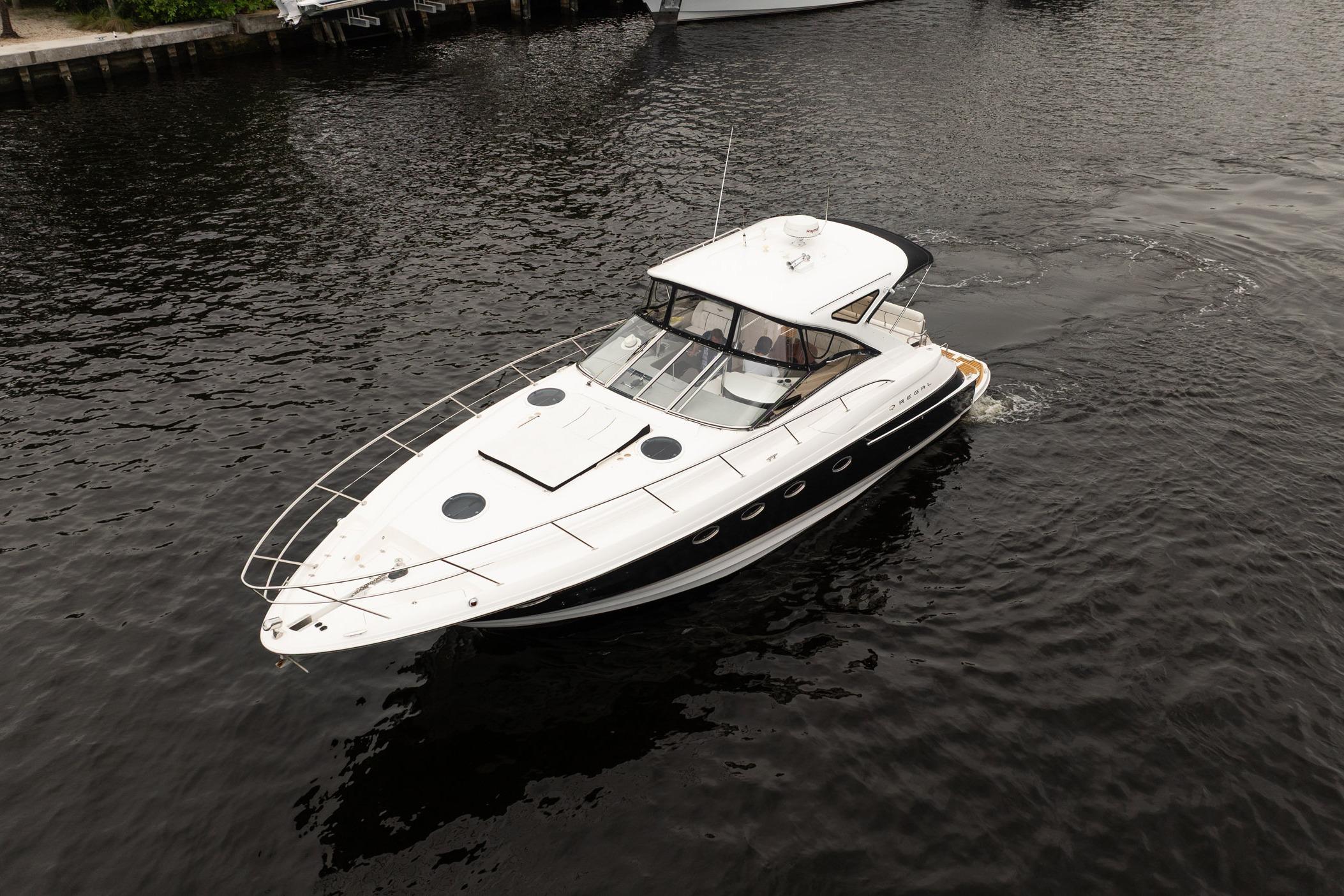 2008 Regal Commodore 4460 yacht cruising on calm waters.