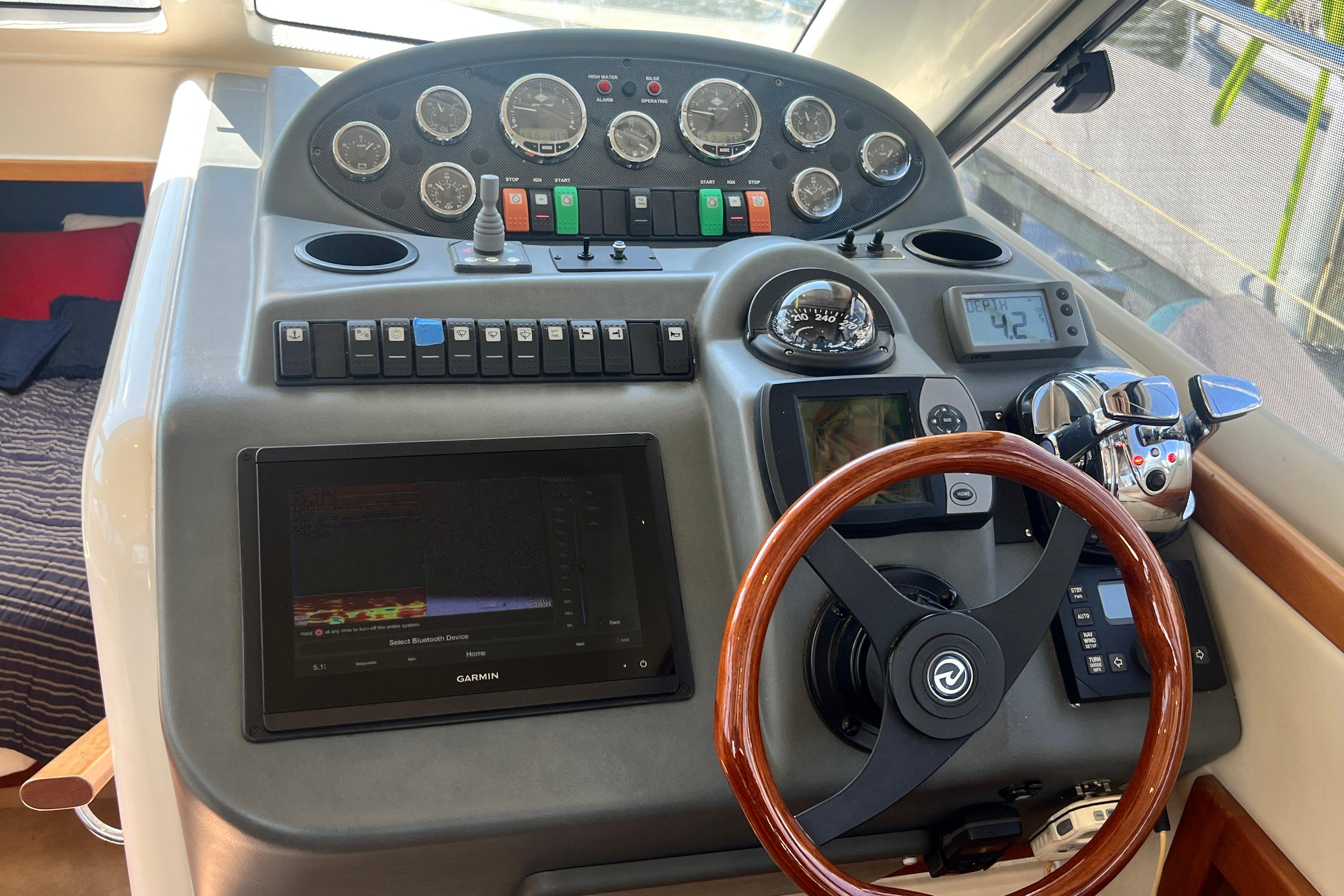 2007 Riviera 33 Flybridge helm with gauges, controls, and Garmin navigation system.