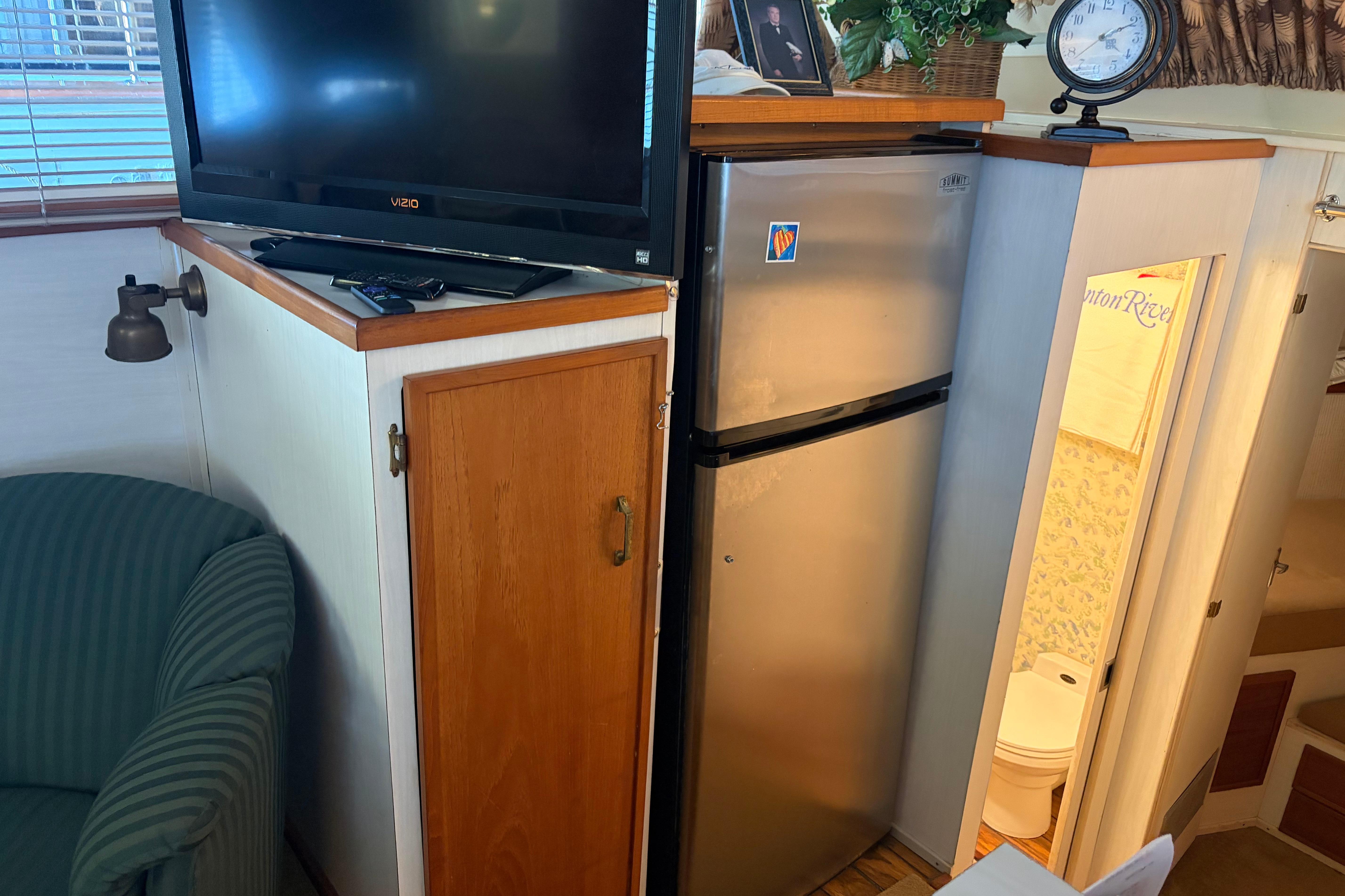 1971 Chris-Craft 42 Commander interior with TV, fridge, and bathroom view.