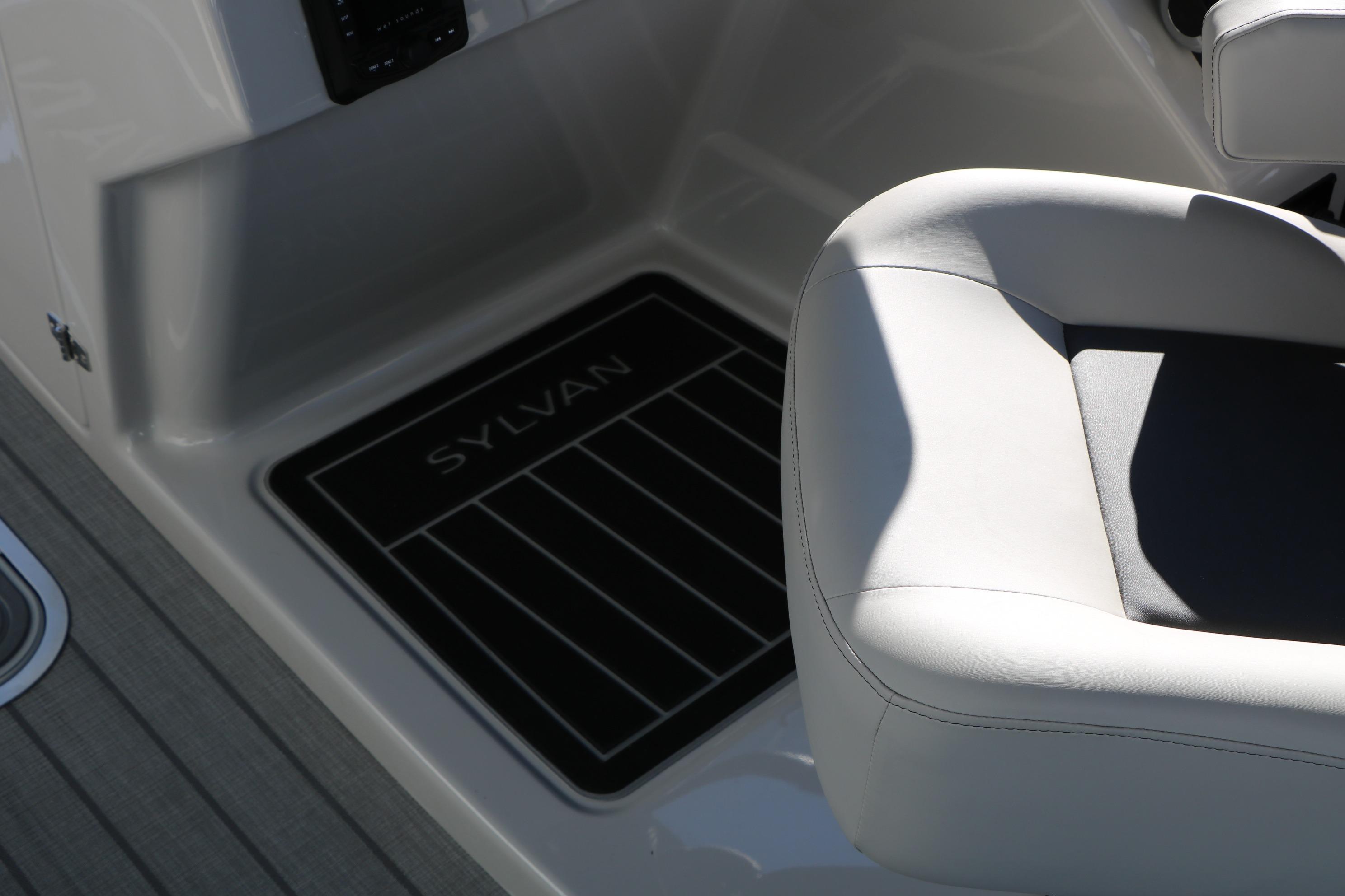 2026 Sylvan L3 CLZ DH boat interior with branded floor mat and cushioned seating.