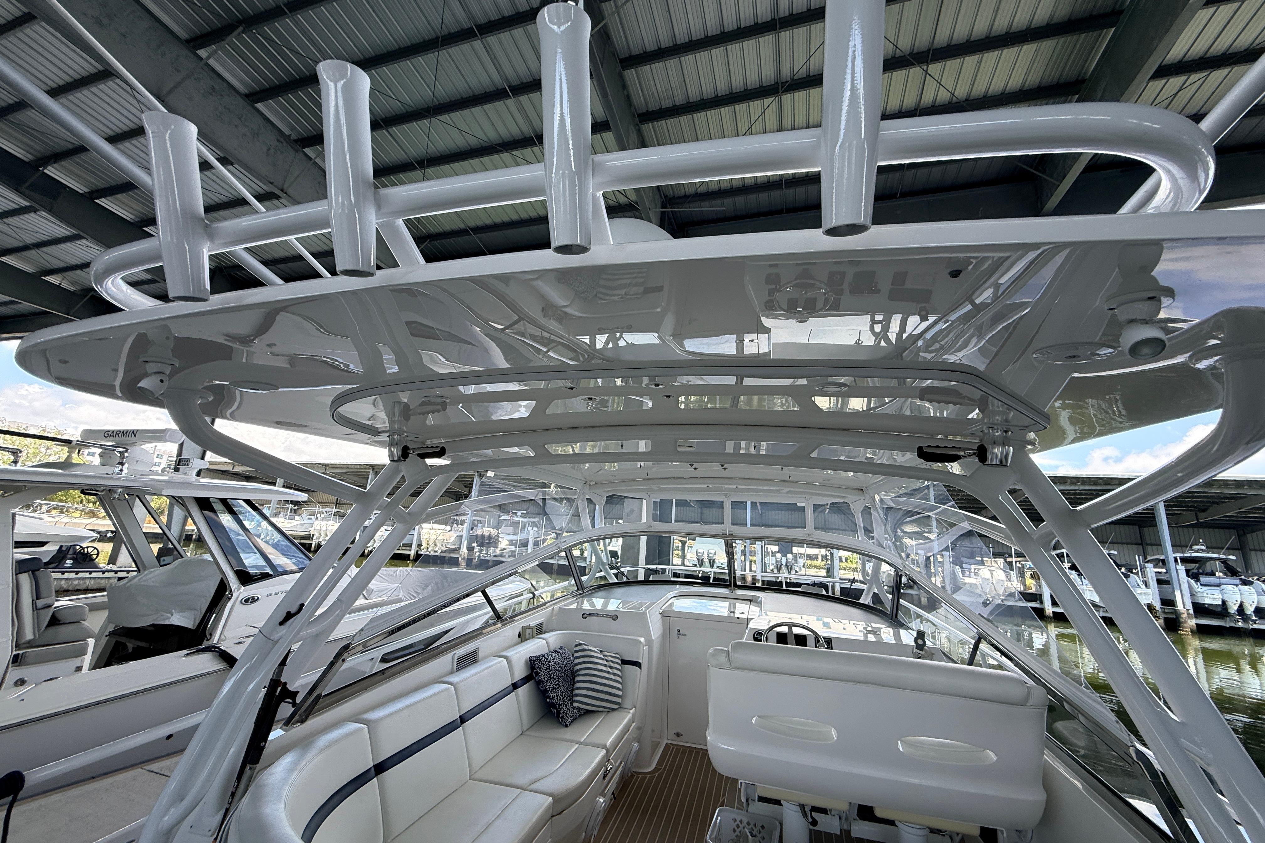 Interior view of a 2016 Intrepid 430 Sport Yacht under a covered dock.