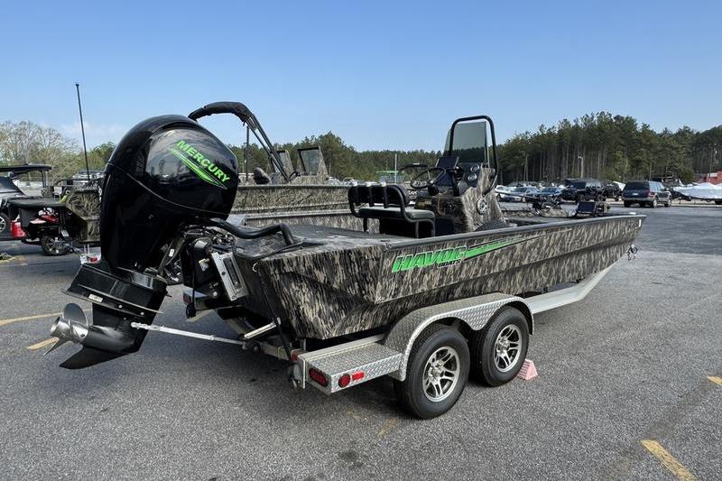 2023 Havoc 1756 MRST boat with Mercury engine on a trailer in a parking lot.