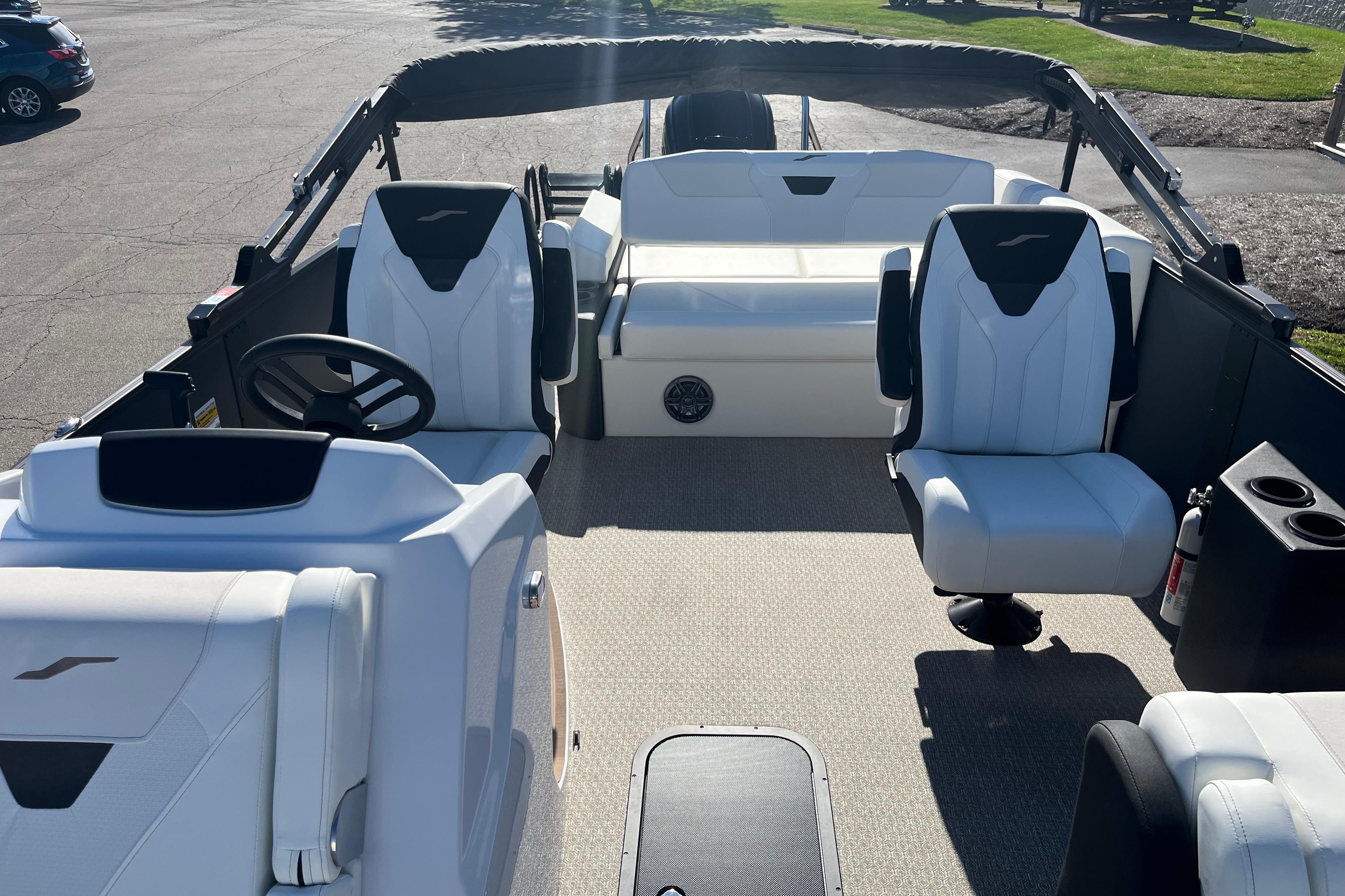 Interior of 2026 Evotti 523CS boat with white seating and steering wheel.