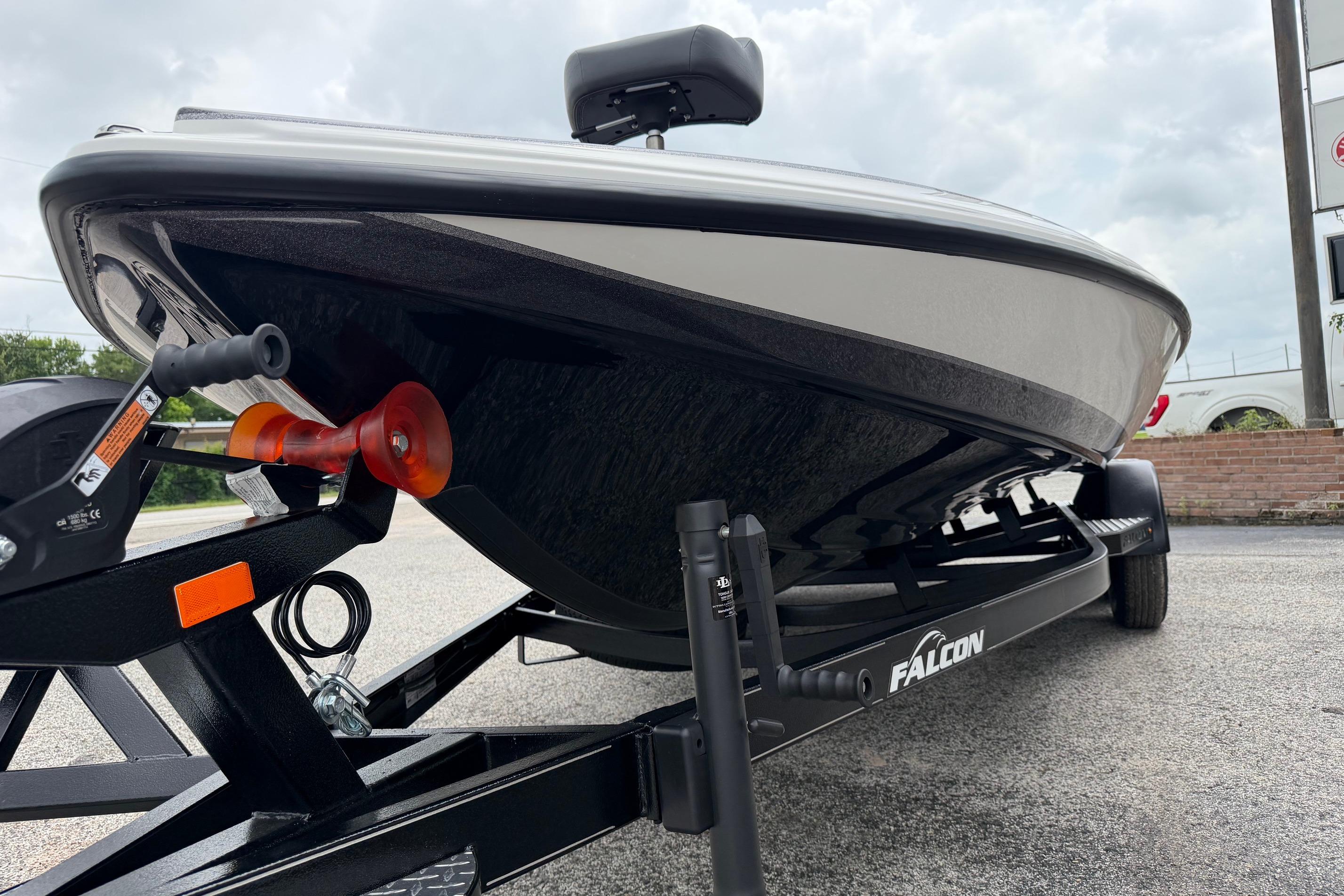 2027 Falcon Boats F215 on trailer, showcasing sleek design and sturdy build.