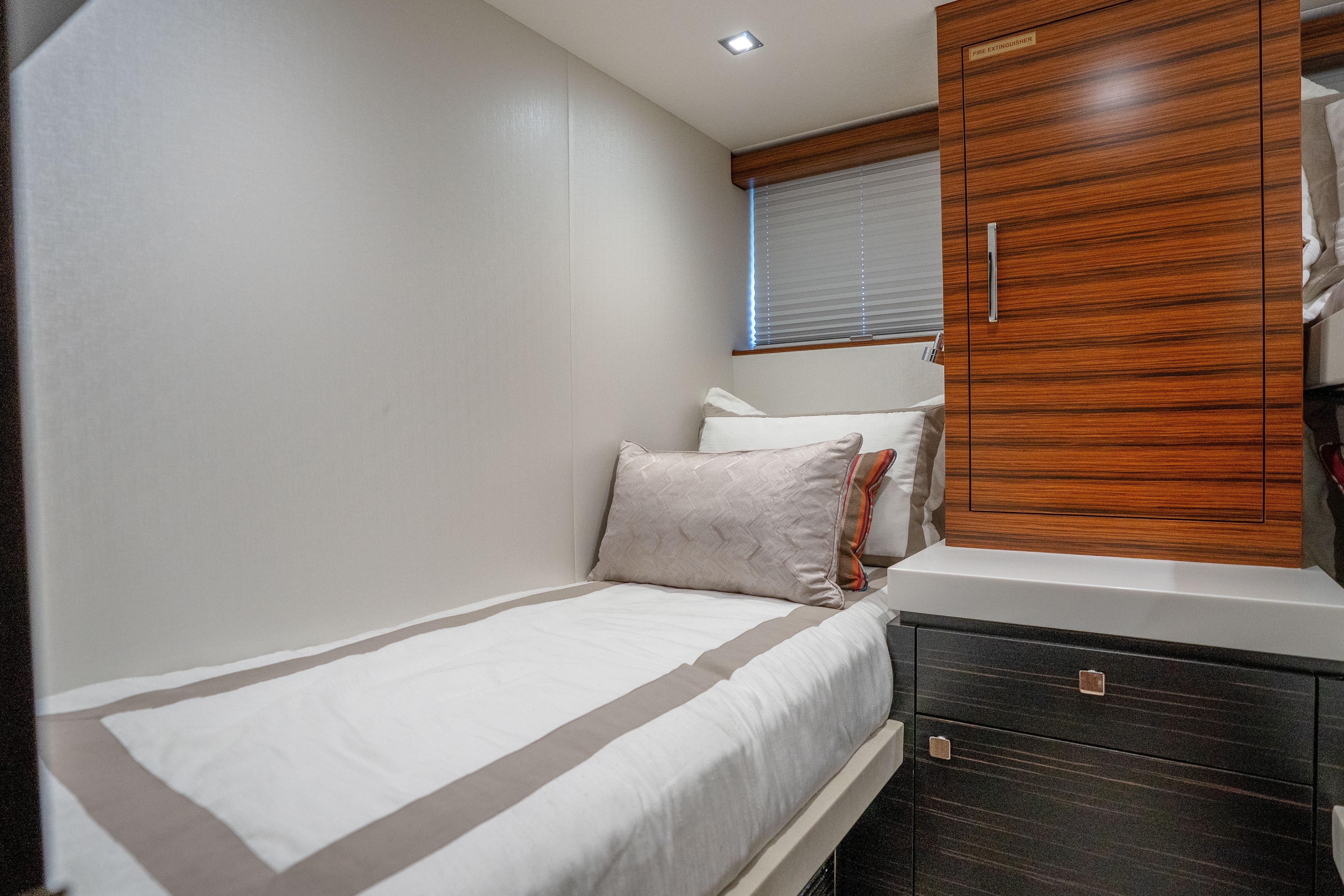 Cozy cabin interior of 2021 Hatteras M75 Panacera yacht with modern wood accents.