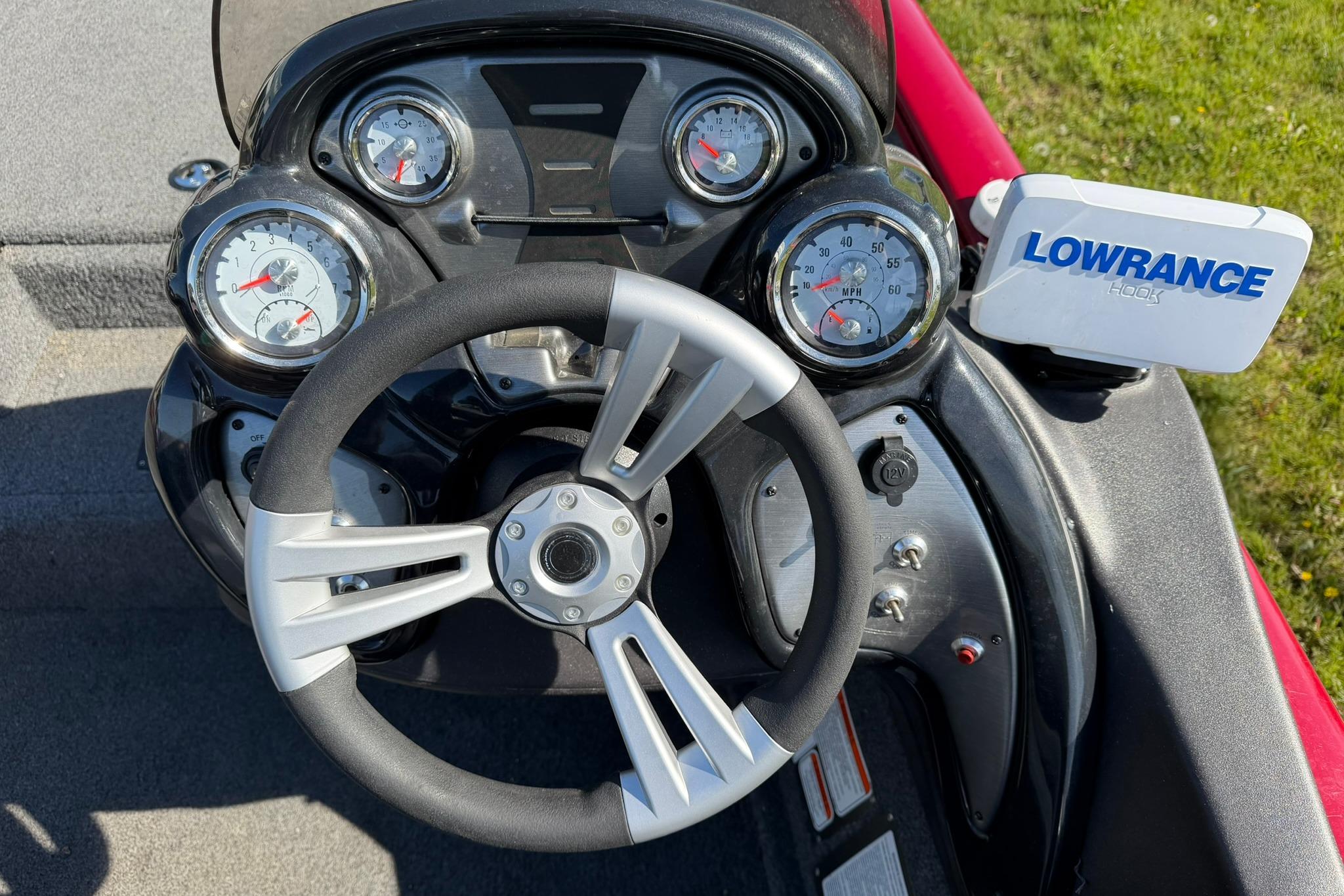 2024 Tracker Pro Team 175 TXW dashboard with steering wheel and Lowrance Hook display.