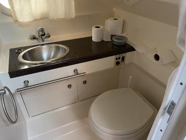2014 Sea Ray 310 Sundancer bathroom with sink, toilet, and countertop.