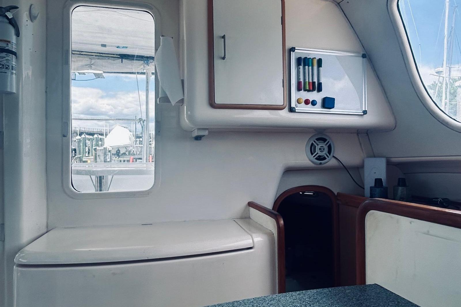 Interior of a 2001 Robertson & Caine Leopard yacht with whiteboard and storage cabinets.