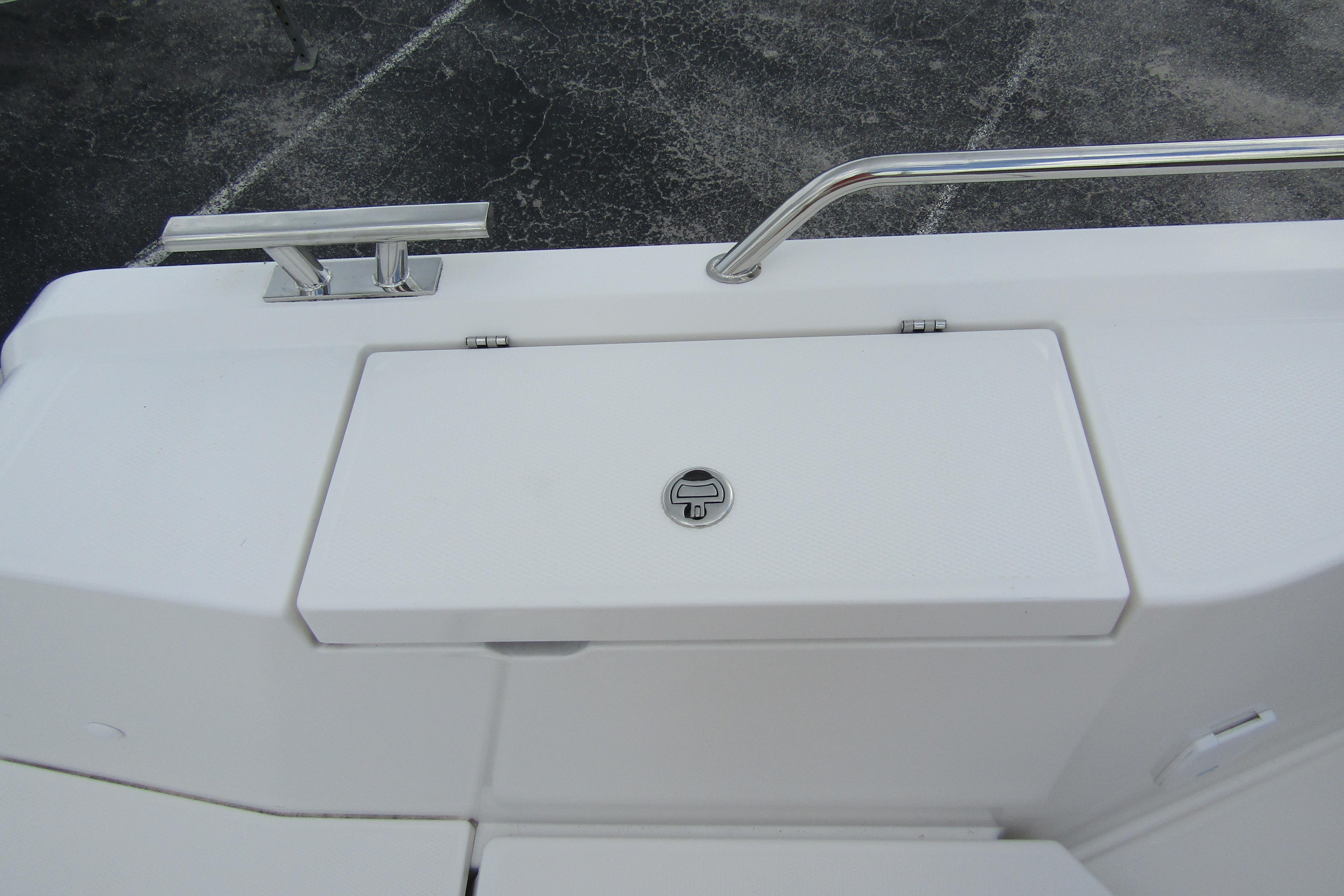 2025 Nimbus Tender 11 boat deck with storage compartment and stainless steel railing.