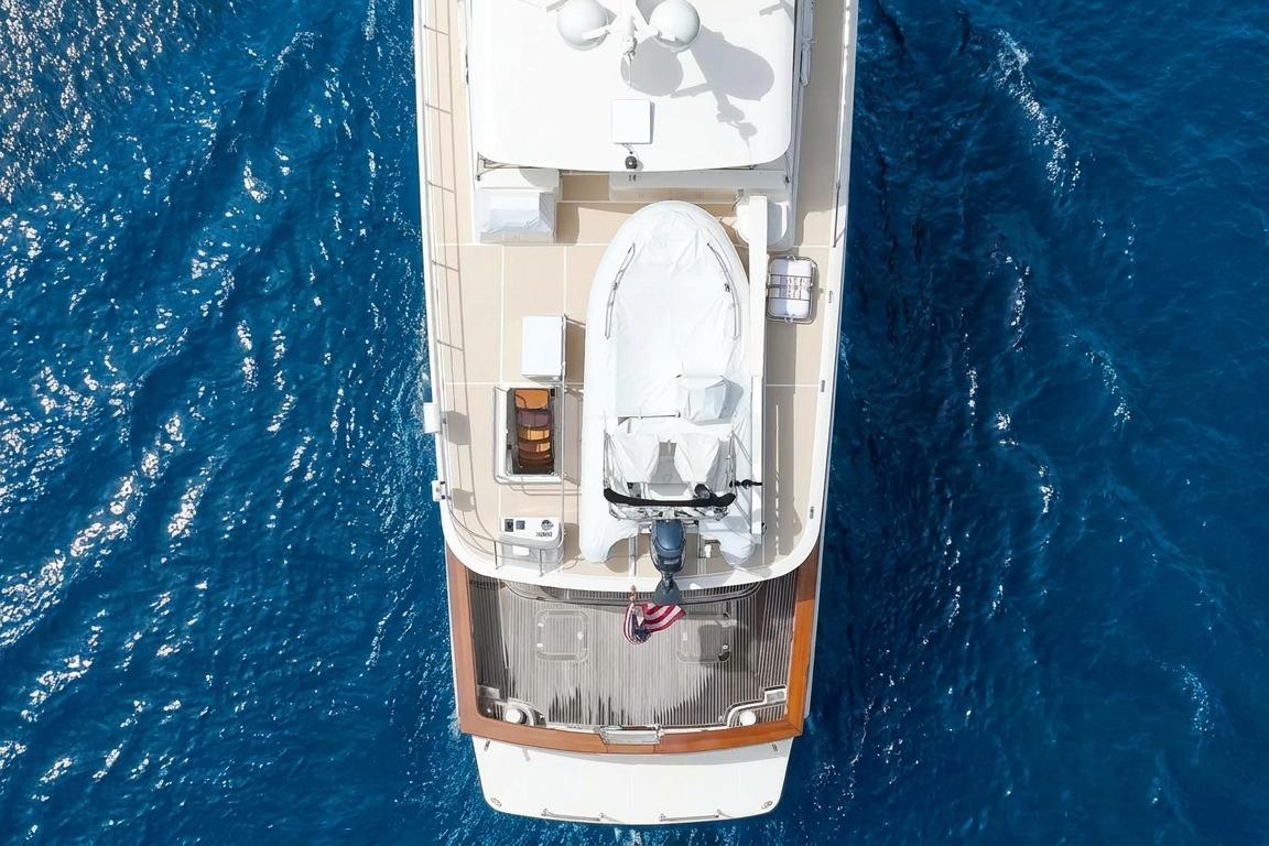 Aerial view of 2006 Fleming 75 yacht on vibrant blue ocean.