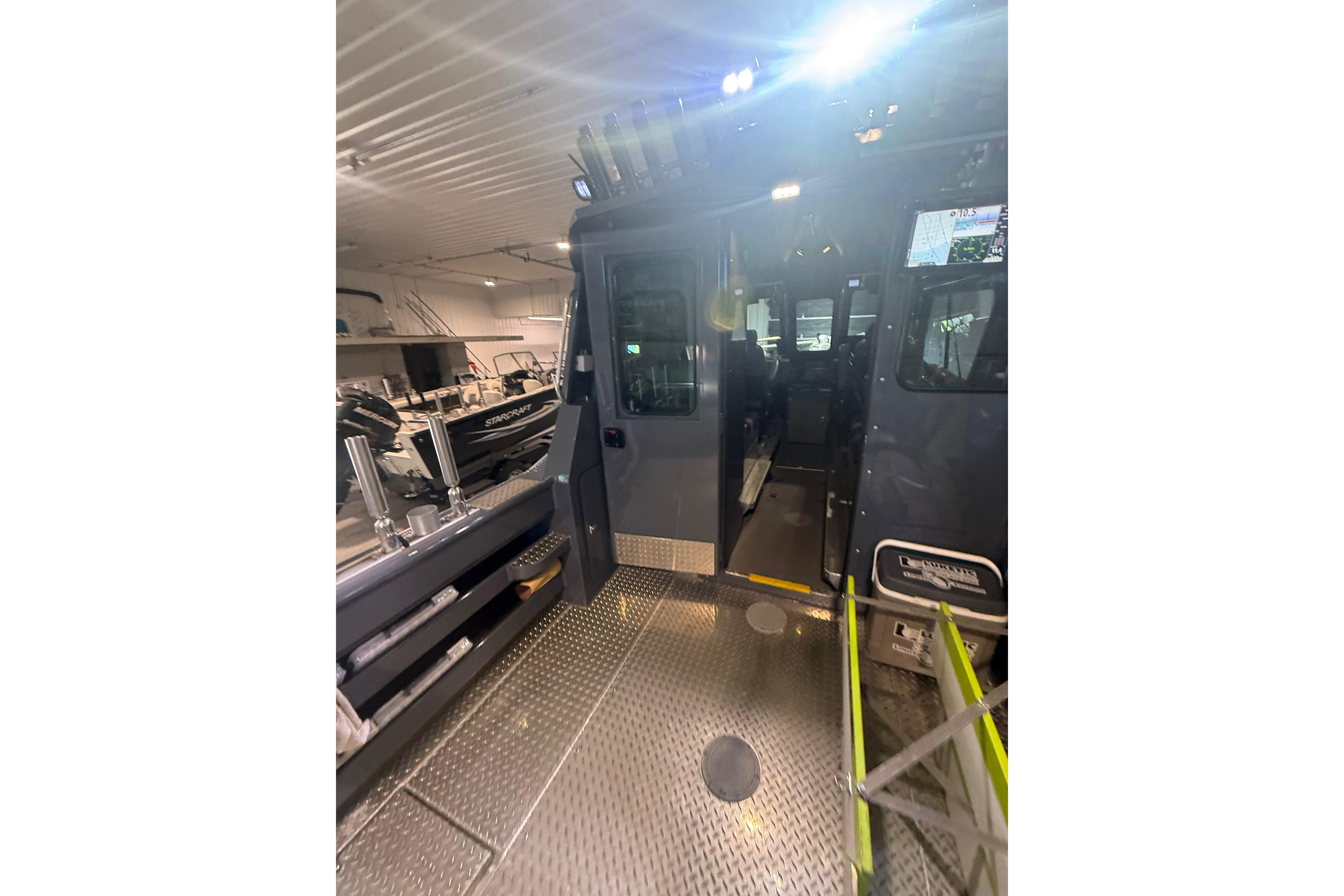 2022 Hewescraft 270 Alaskan Hardtop interior view in a showroom setting.