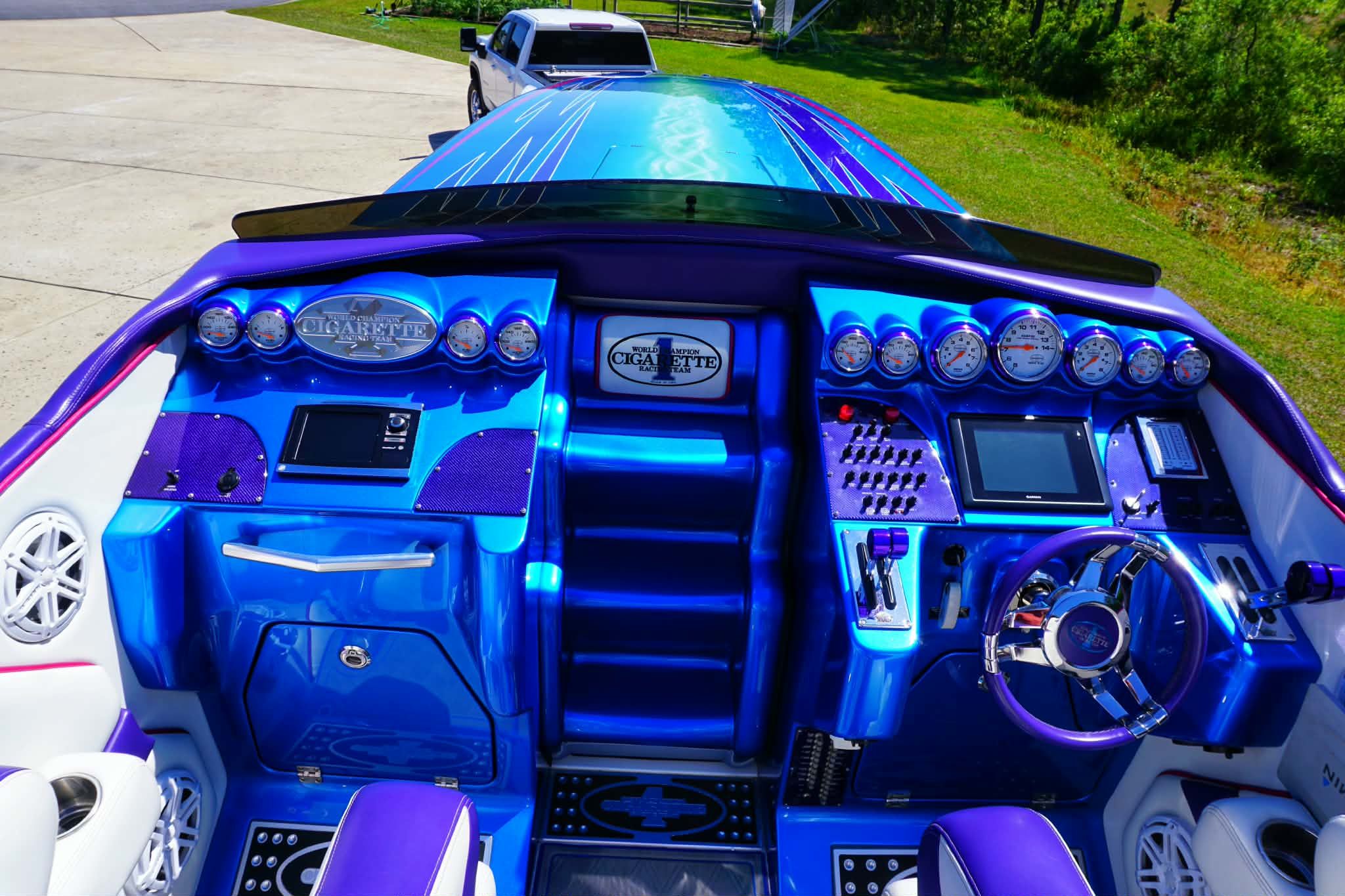 Cockpit of a 2018 Cigarette TopGun Unlimited boat, blue interior.