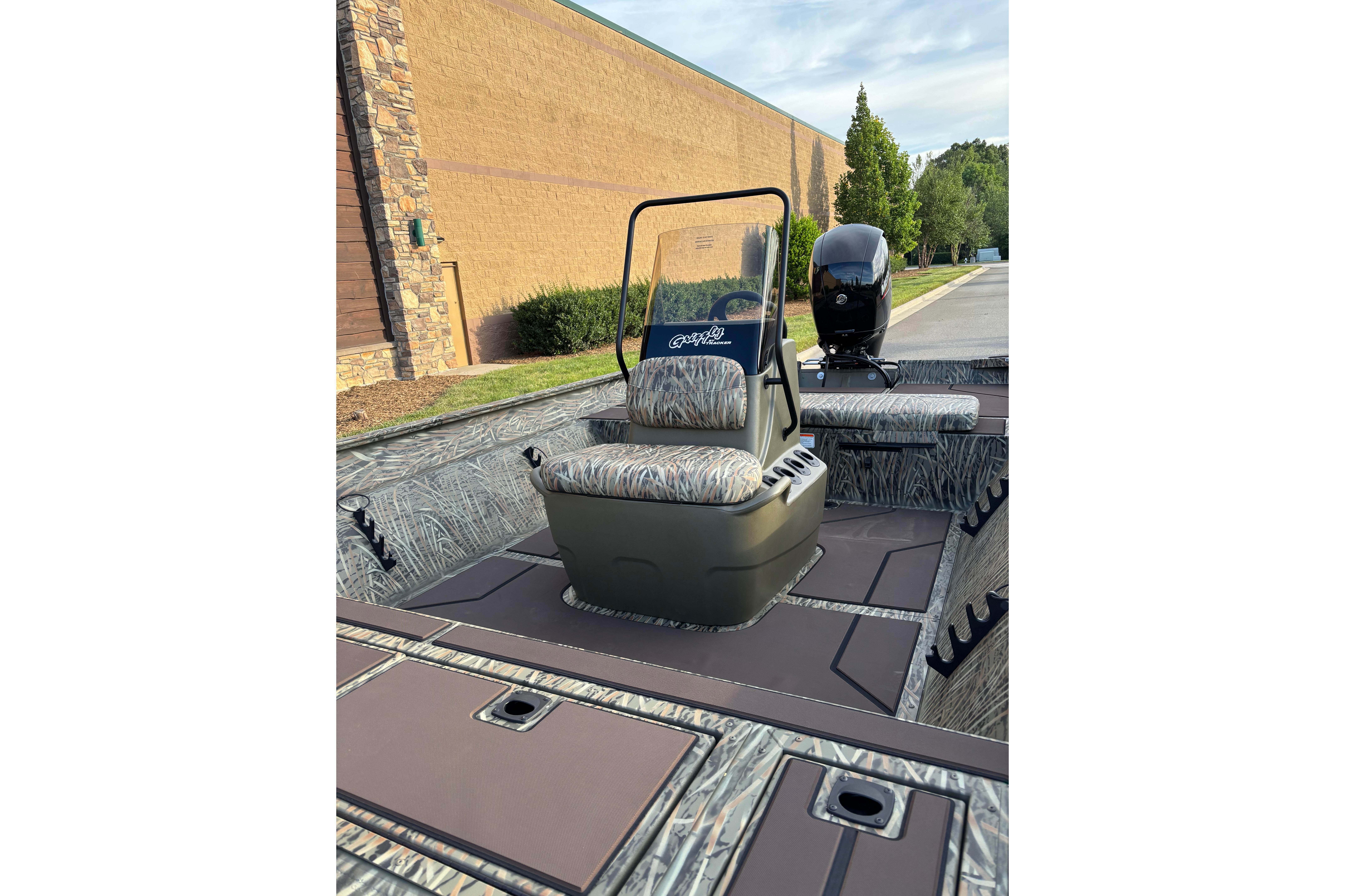 2026 Tracker Grizzly 2072 CC boat interior with camo seating and steering console.