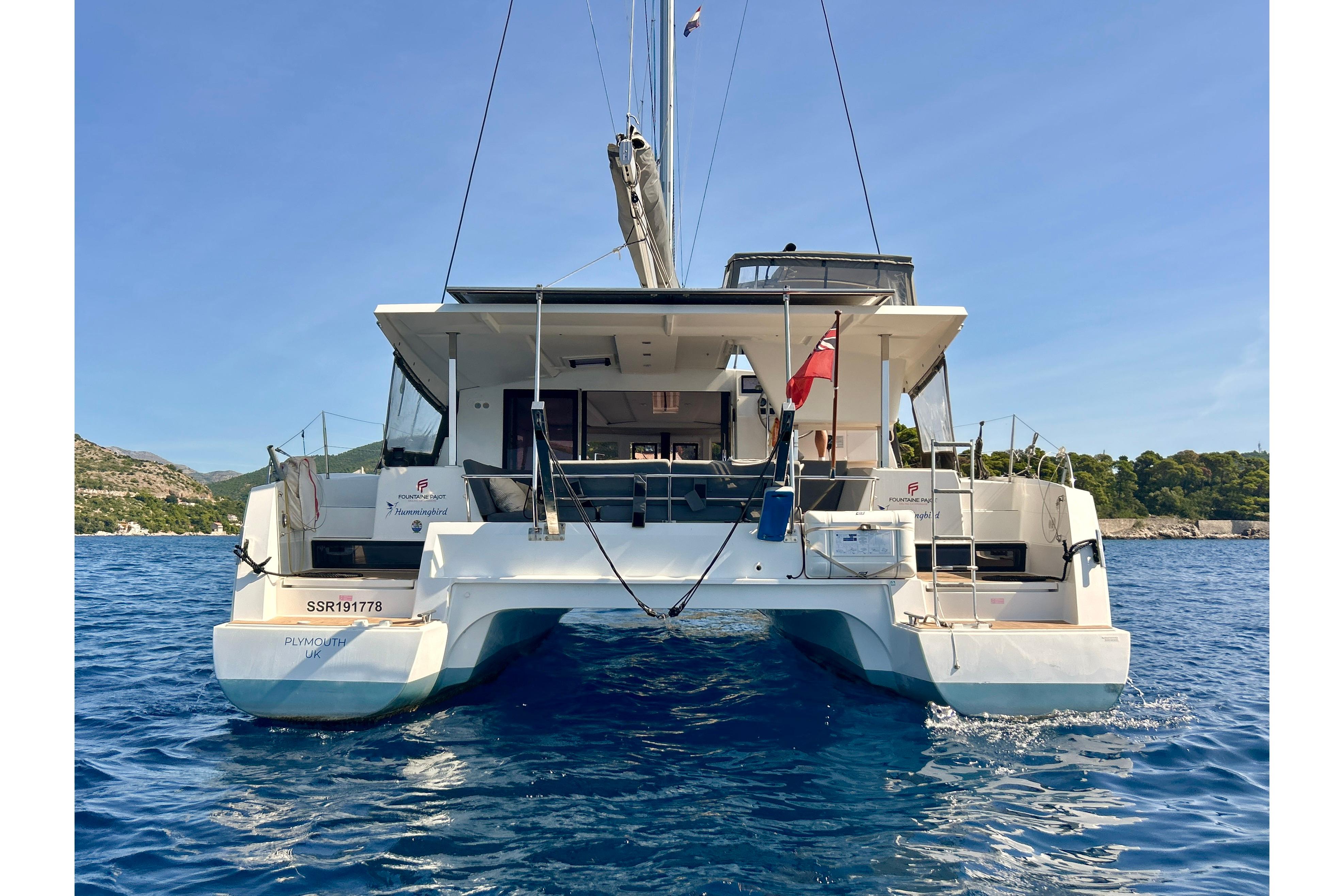 2021 Fountaine Pajot Isla 40 catamaran on blue water, rear view.