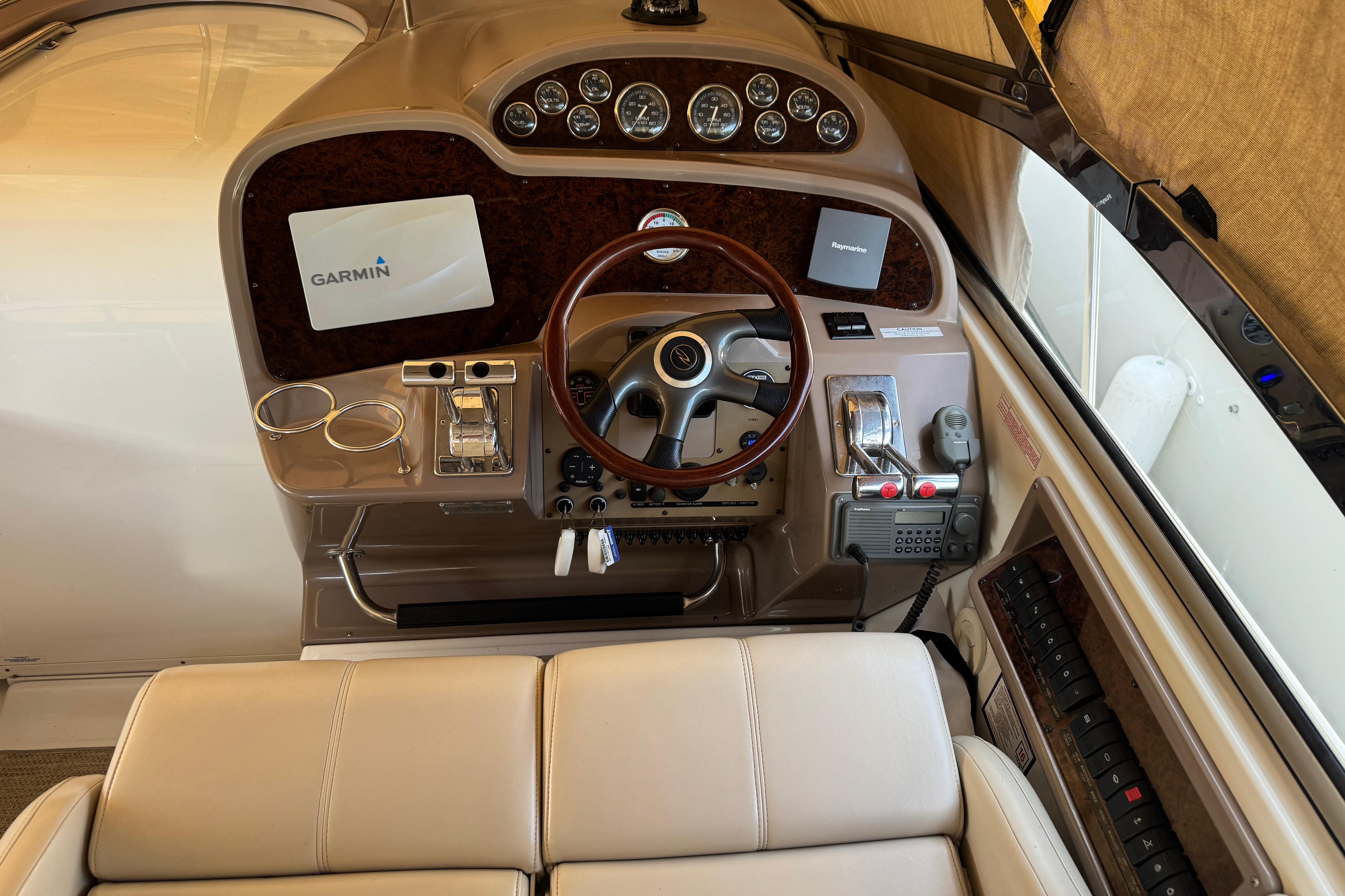 2007 Regal Commodore 3860 helm with Garmin navigation, wood accents, and leather seating.