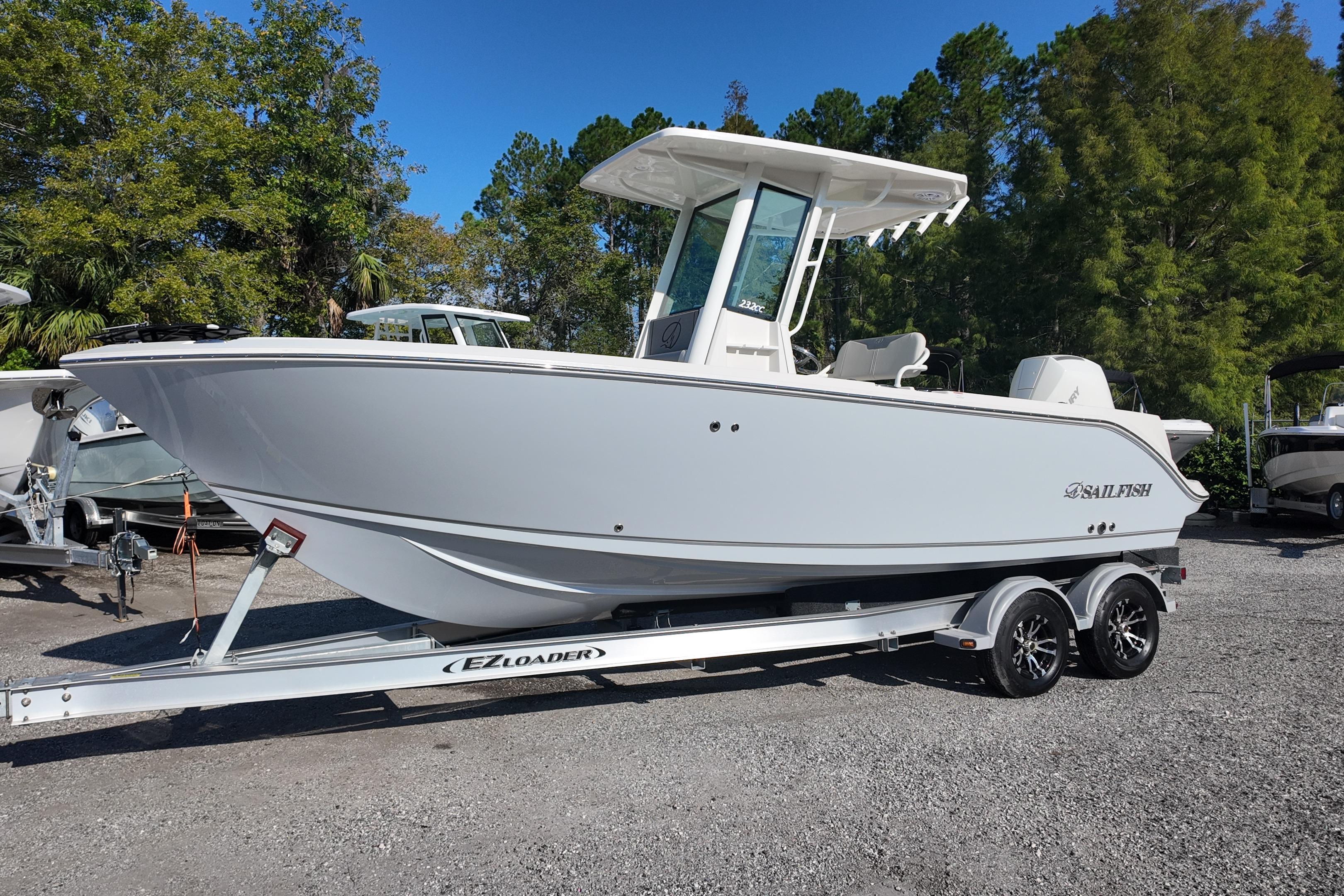 2026 Sailfish 232 CC boat on EZ Loader trailer, parked outdoors.