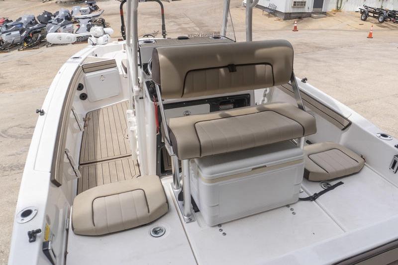 2023 Yamaha Boats 195 FSH Sport interior with beige seating and storage area.