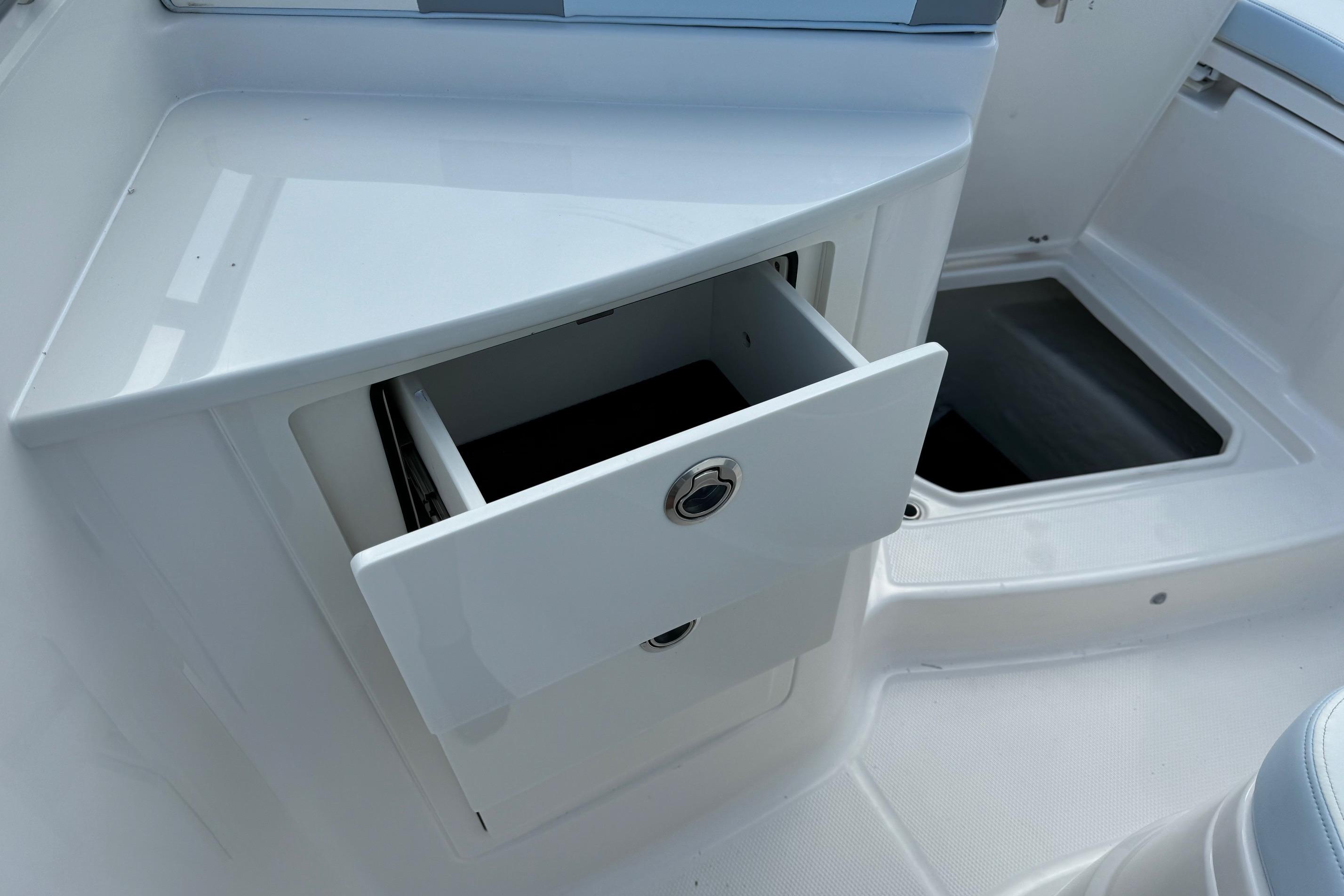2025 Robalo R360 Center Console boat with open storage drawer.