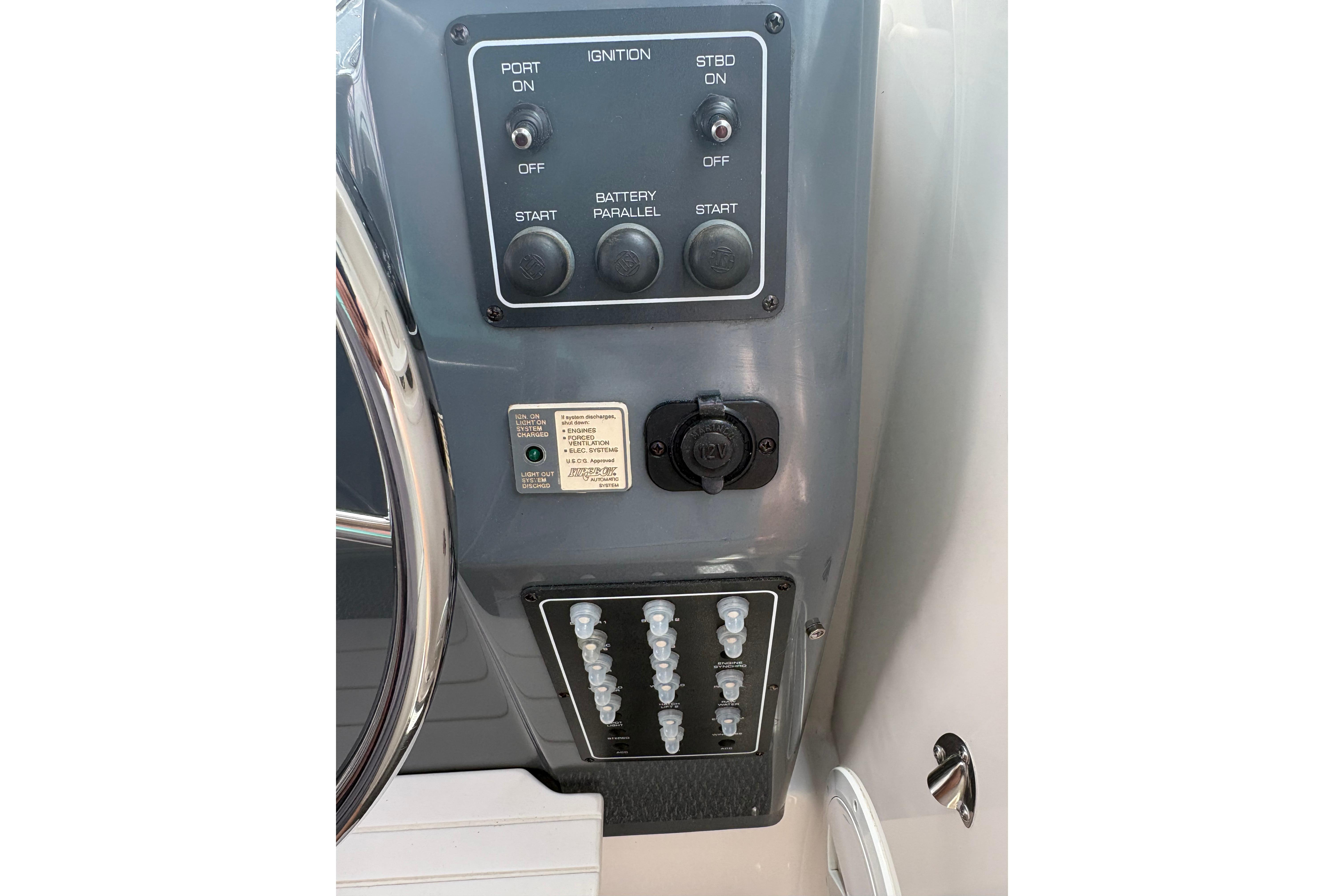 Control panel of a 1999 Tiara Yachts 3100 Open, featuring ignition switches and circuit breakers.